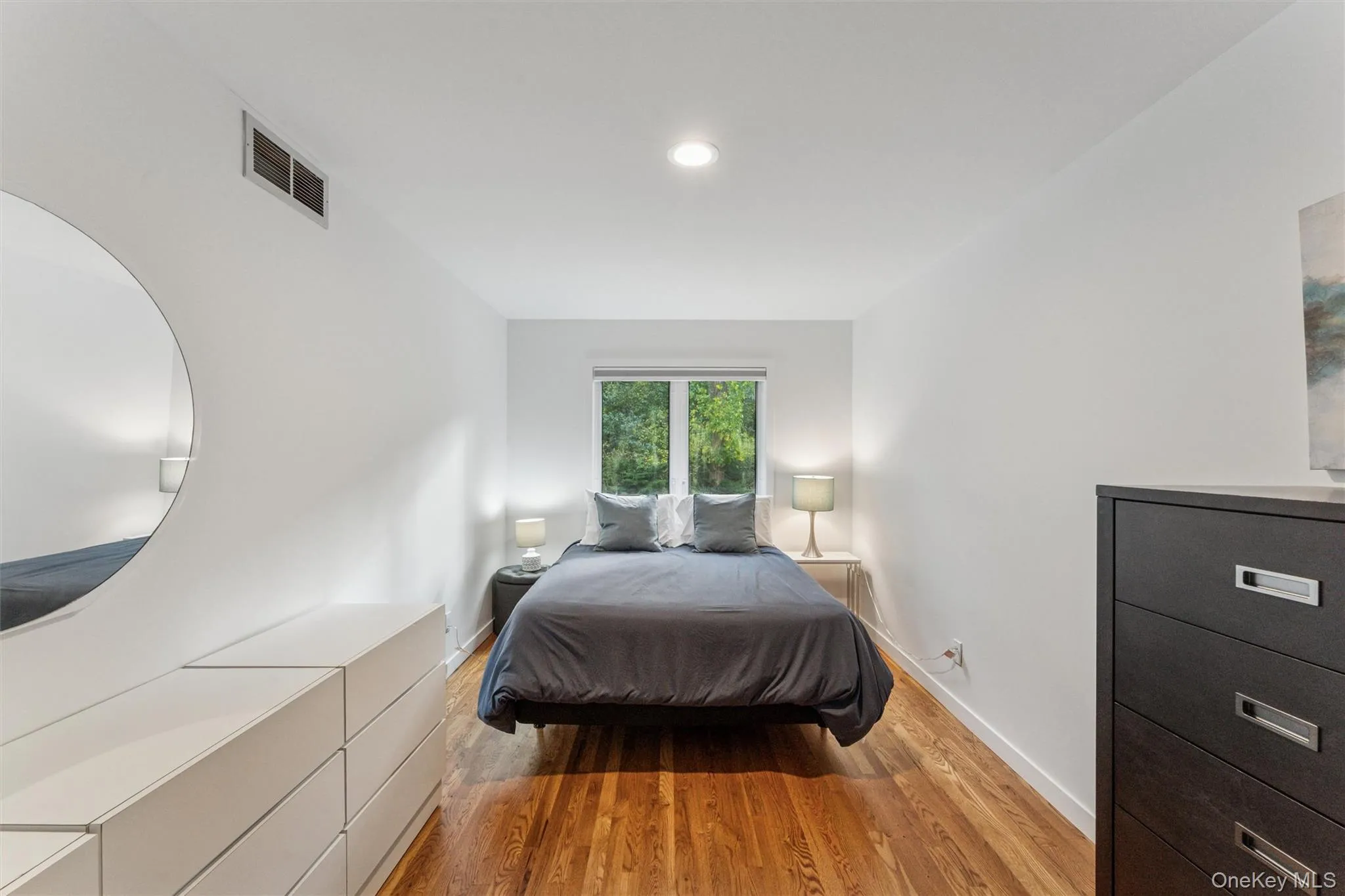 Bedroom with light wood-type flooring and recessed lighting Bedroom with light wood-type flooring and recessed lighting