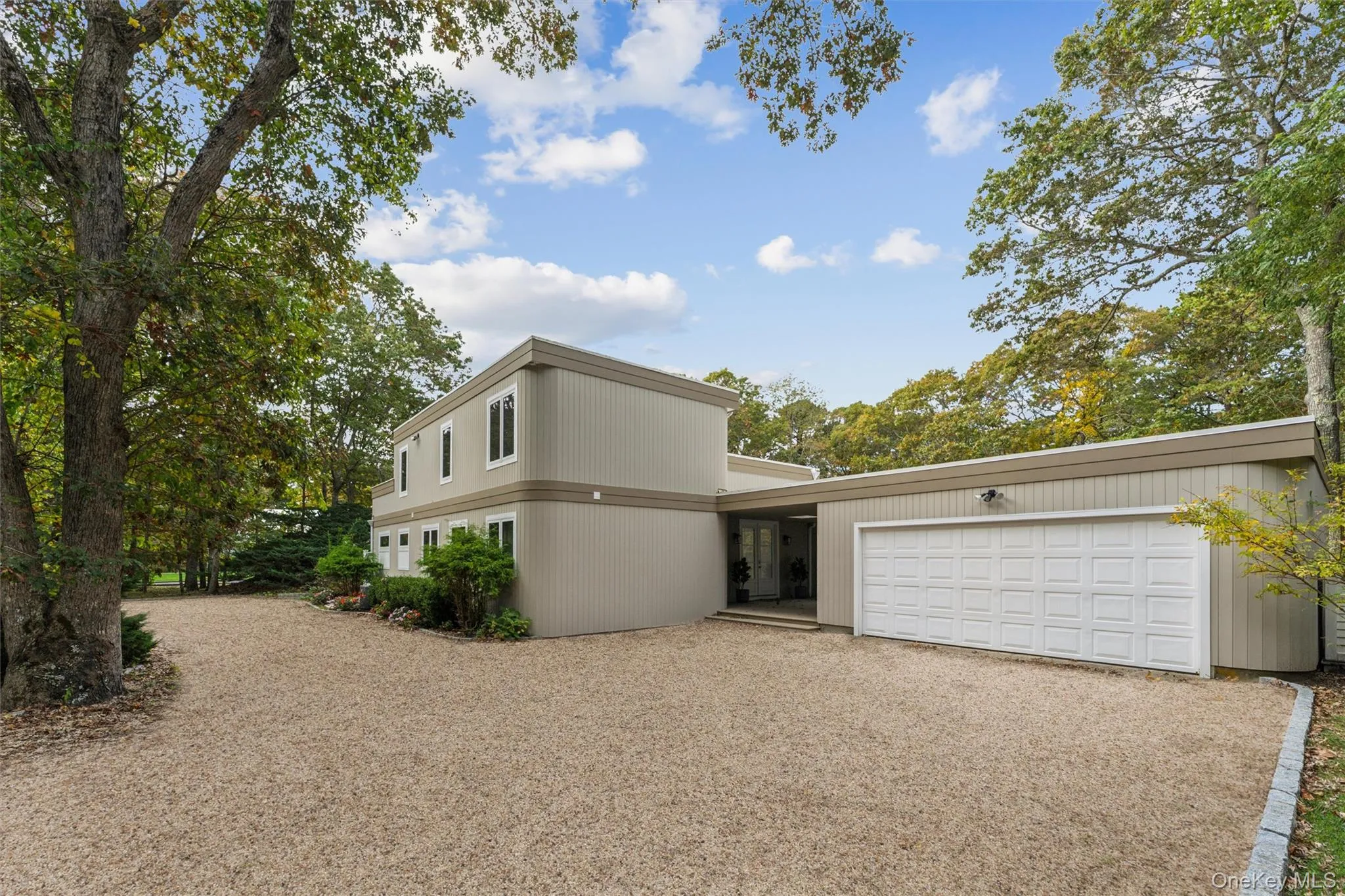 View of front of house with gravel driveway and a garage View of front of house with gravel driveway and a garage
