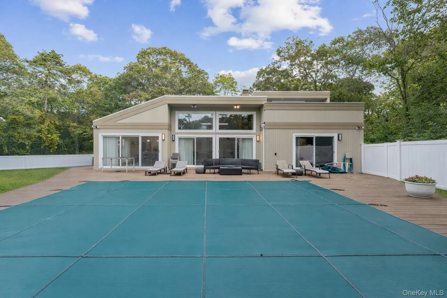 Rear view of house featuring an outdoor hangout area and a patio Rear view of house featuring an outdoor hangout area and a patio