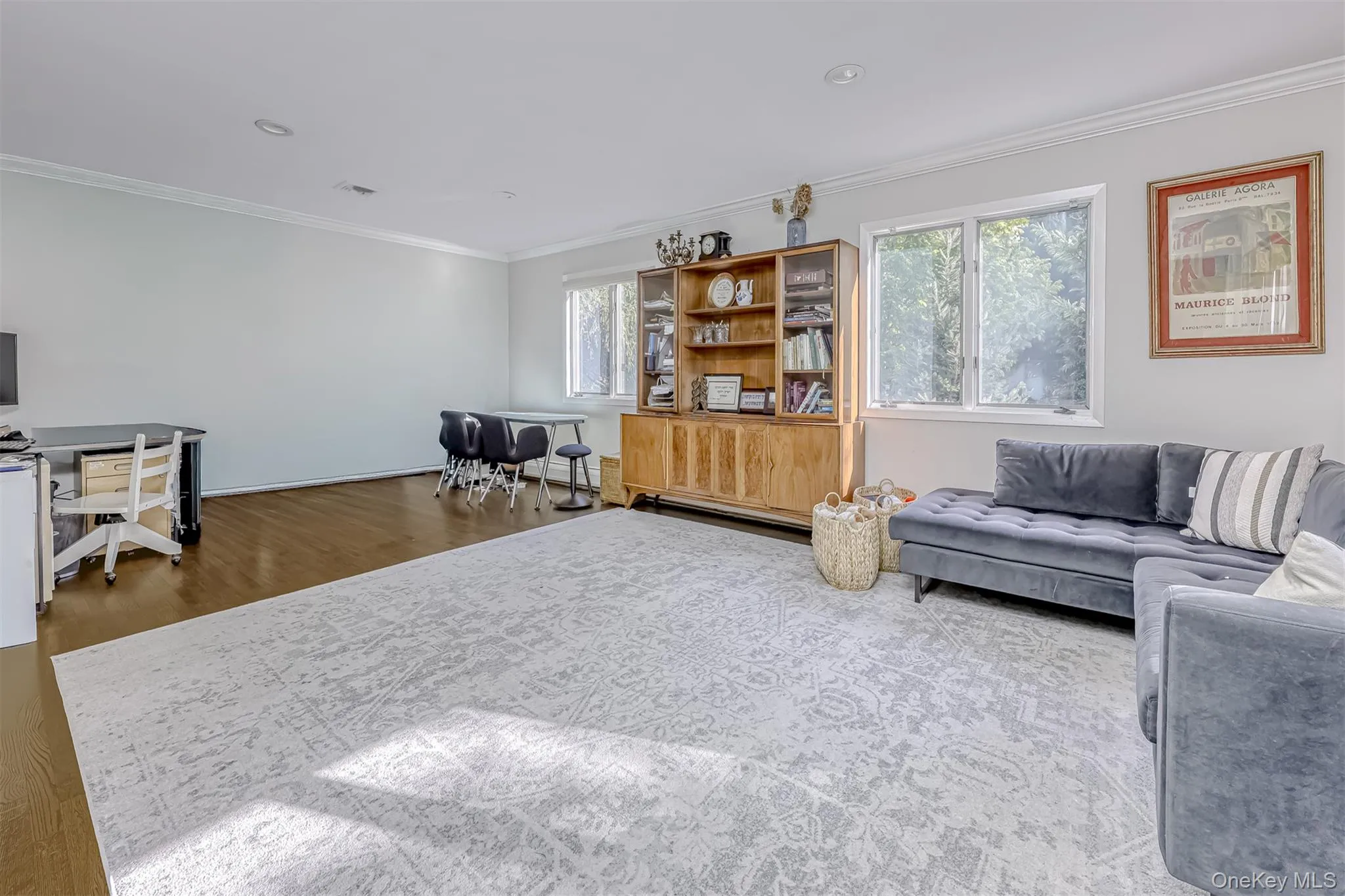 Living room featuring ornamental molding, wood finished floors, and a desk Living room featuring ornamental molding, wood finished floors, and a desk