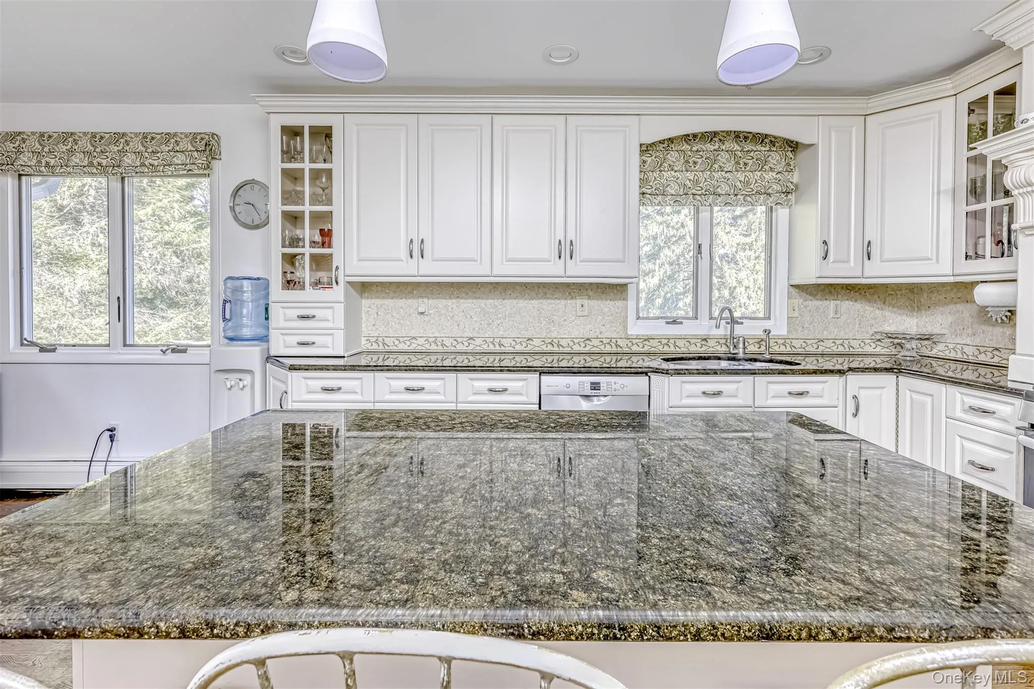 Kitchen with glass insert cabinets and dark stone countertops Kitchen with glass insert cabinets and dark stone countertops