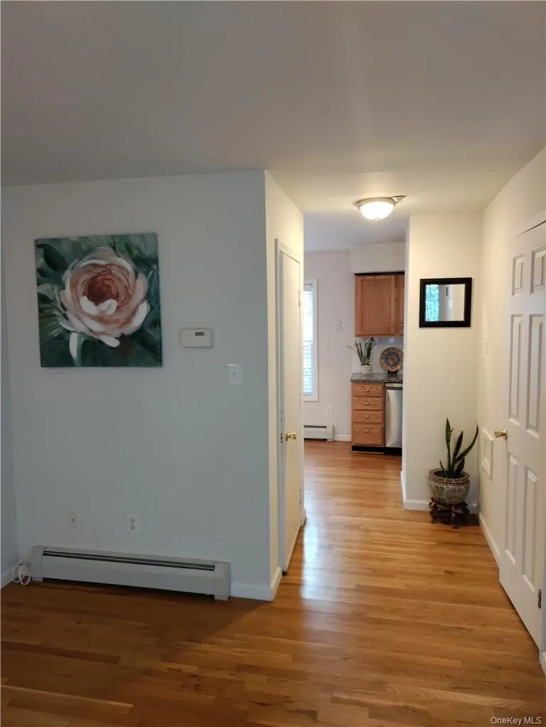Hallway featuring hardwood flooring Hallway featuring hardwood flooring