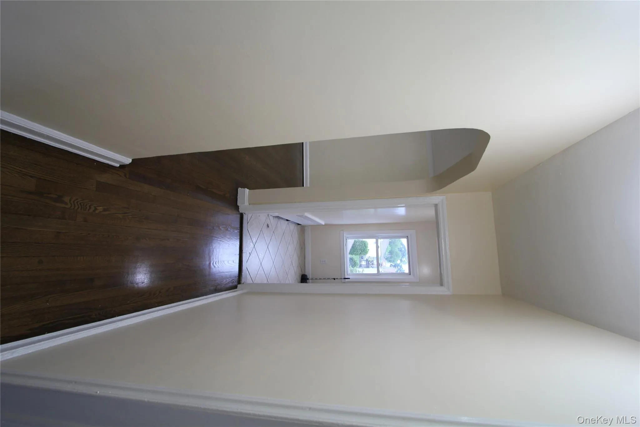 Corridor featuring dark wood-style flooring and arched walkways Corridor featuring dark wood-style flooring and arched walkways