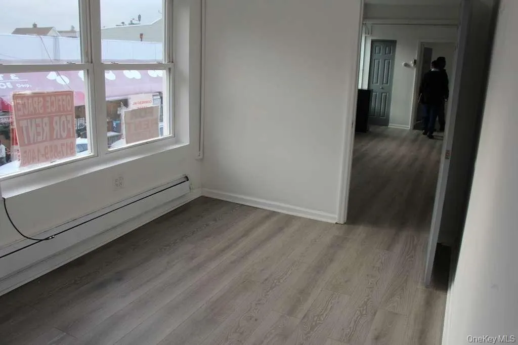 Empty room featuring baseboard heating and light wood-style floors Empty room featuring baseboard heating and light wood-style floors