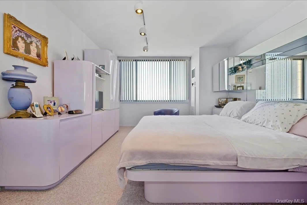 Bedroom with track lighting and light colored carpet Bedroom with track lighting and light colored carpet
