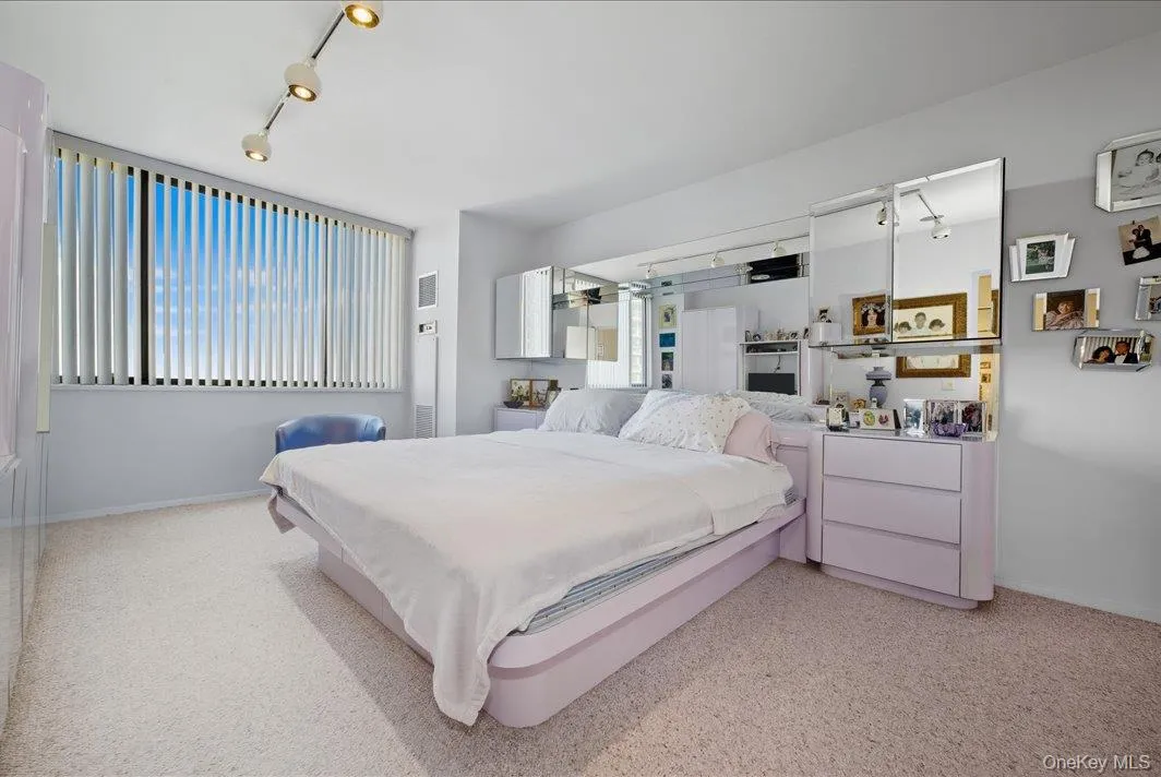 Bedroom featuring track lighting and baseboards Bedroom featuring track lighting and baseboards