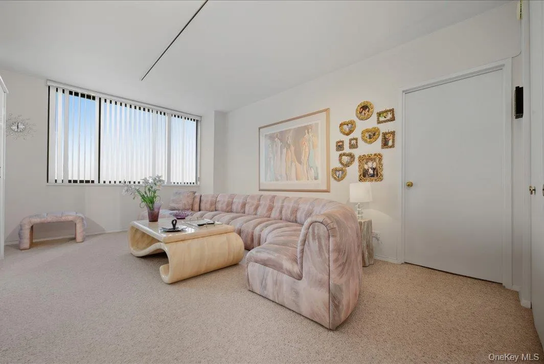 Living area featuring carpet flooring and baseboards Living area featuring carpet flooring and baseboards