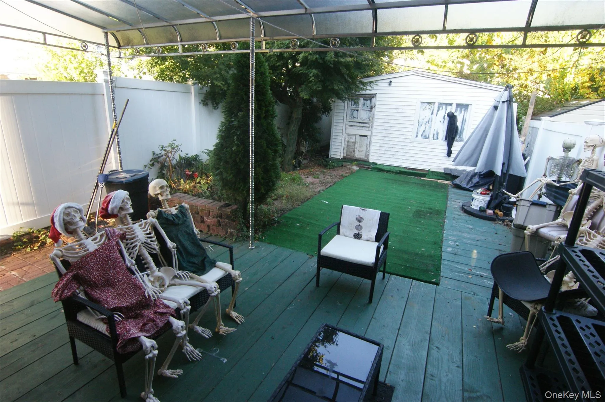 Deck featuring an outbuilding and a fenced backyard Deck featuring an outbuilding and a fenced backyard