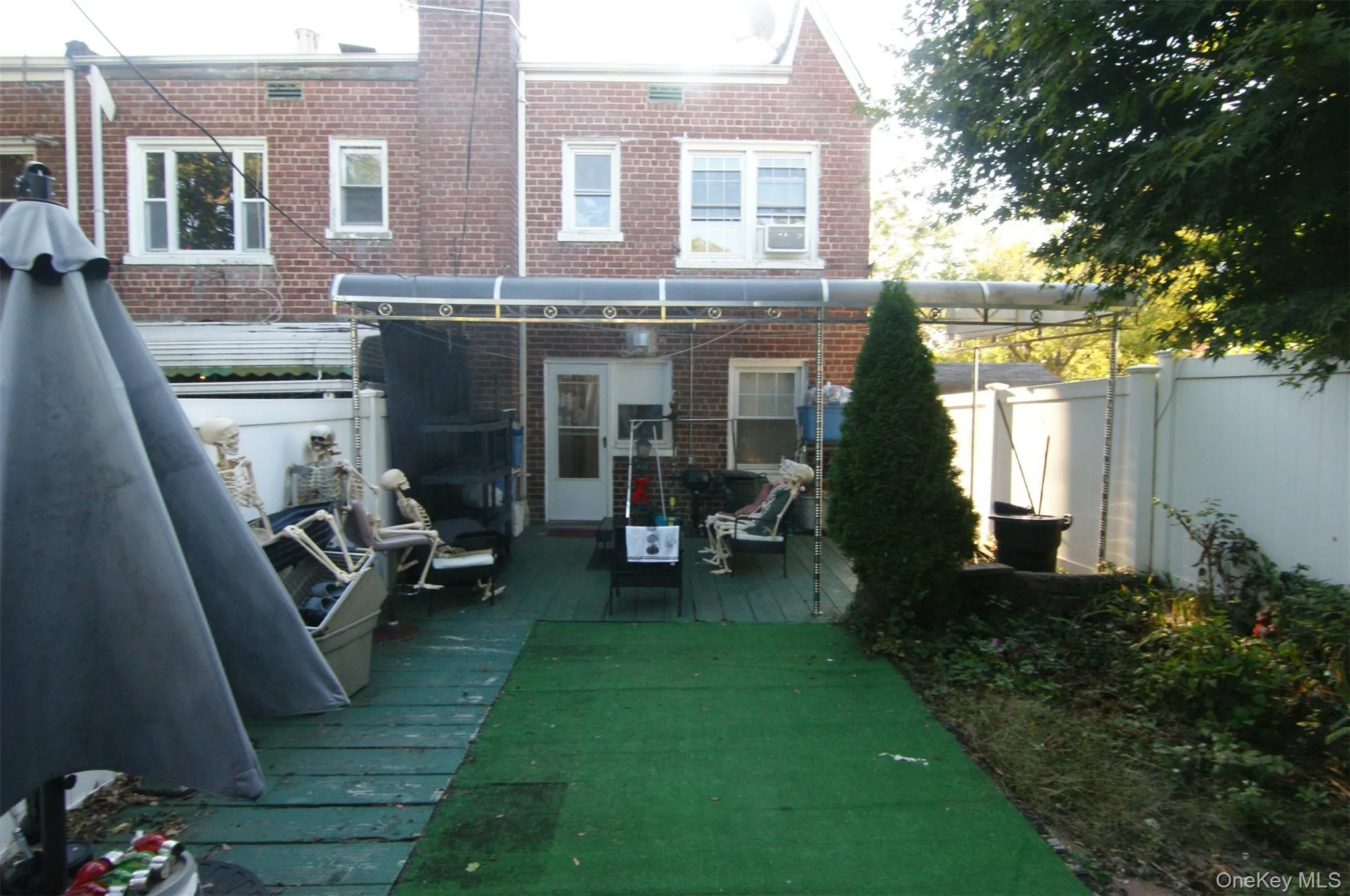 Back of house with brick siding and a deck Back of house with brick siding and a deck