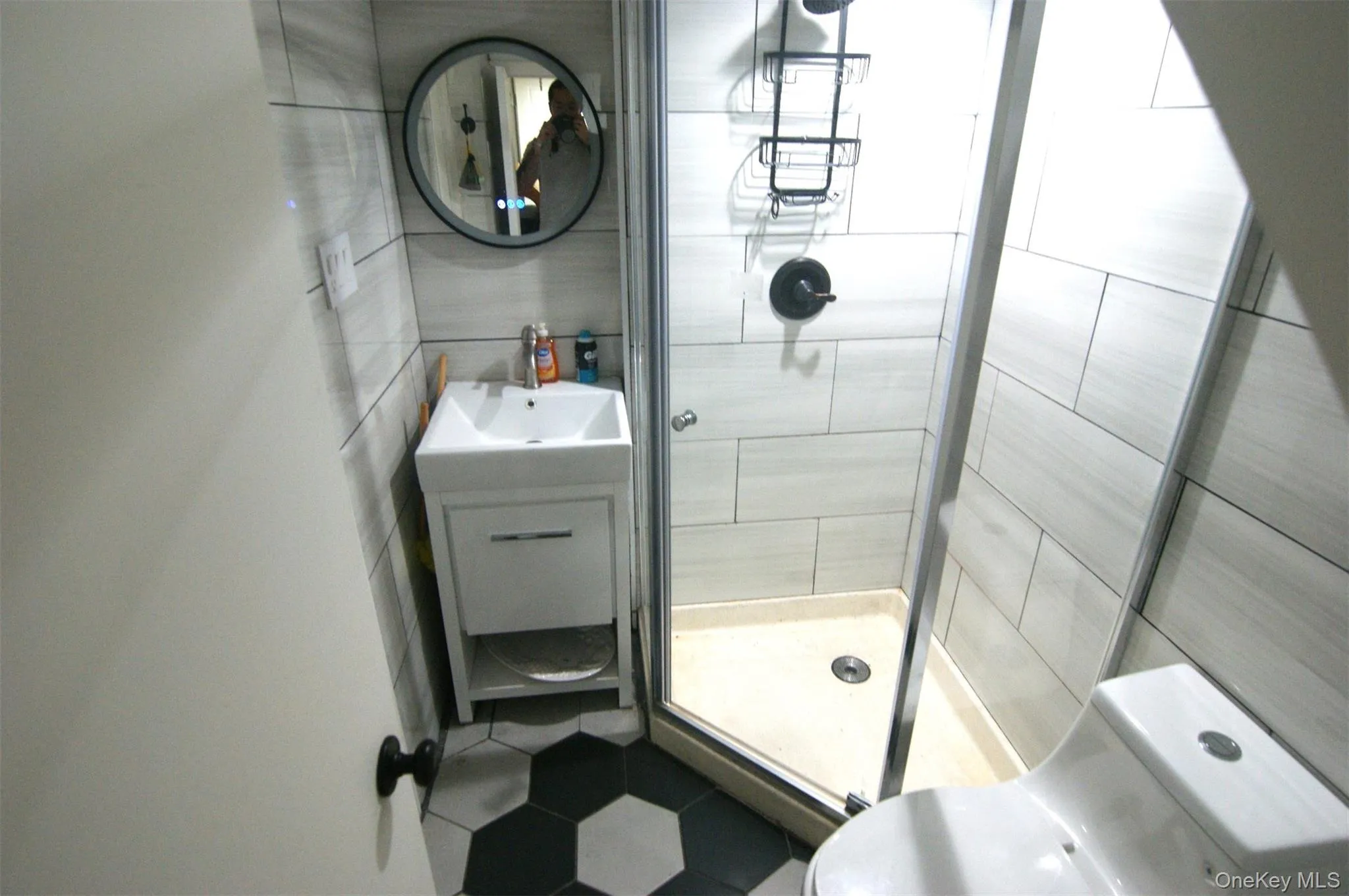 Full bath with tile walls, a shower stall, and vanity Full bath with tile walls, a shower stall, and vanity