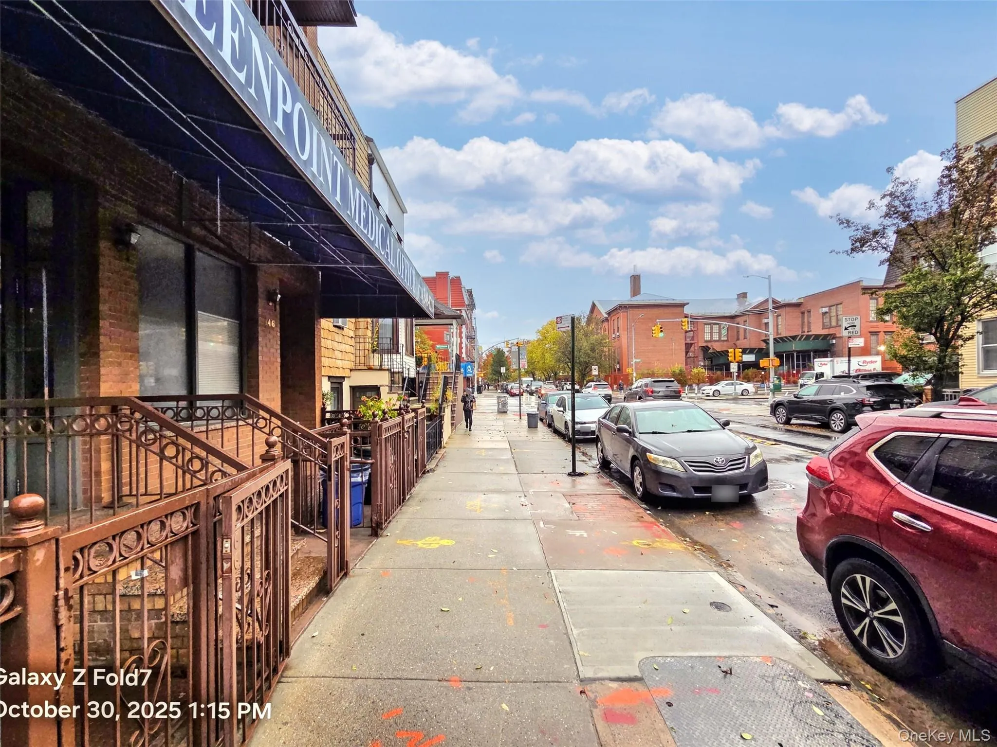 View of asphalt street with sidewalks, street lights, and curbs View of asphalt street with sidewalks, street lights, and curbs