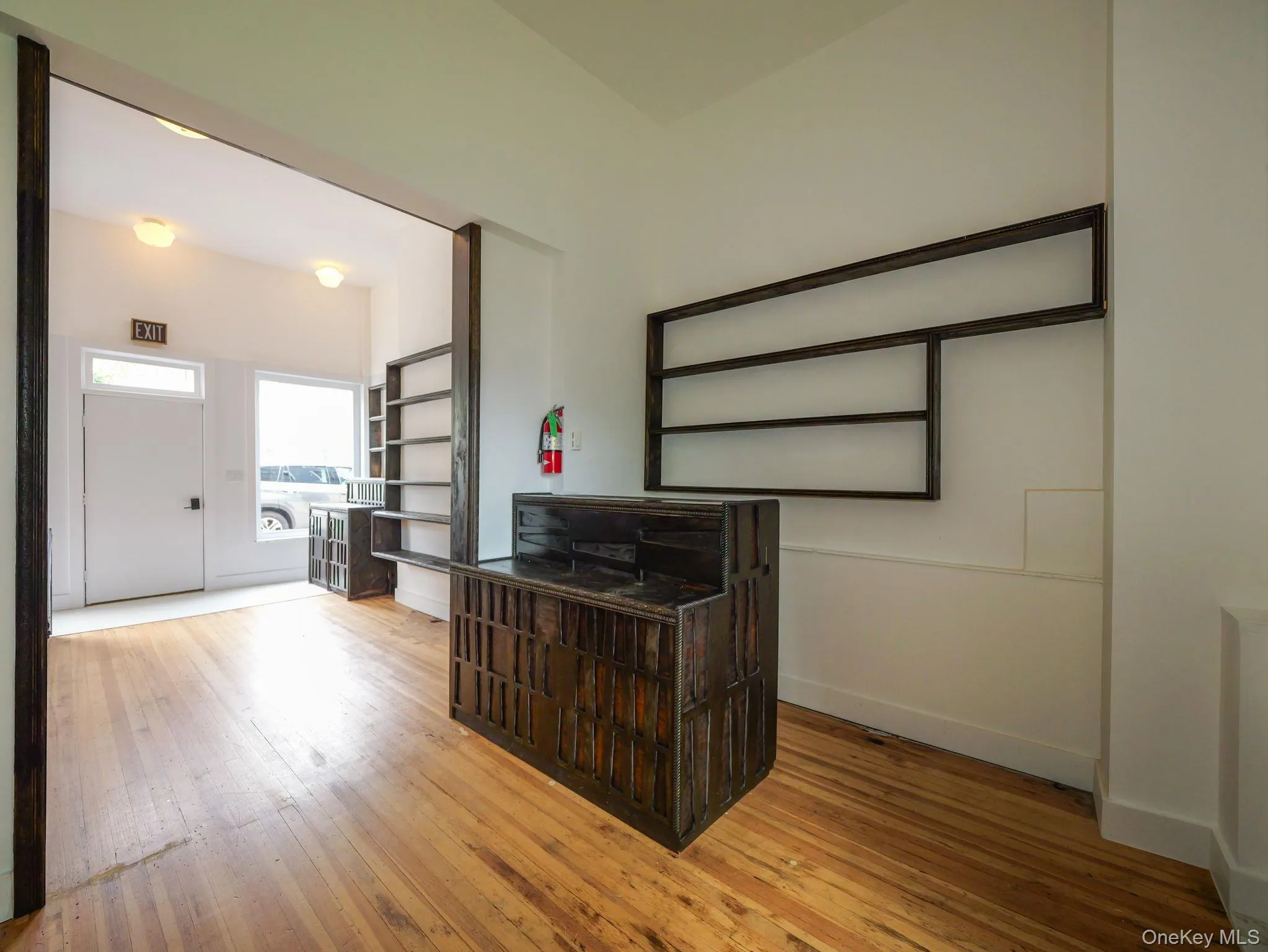Space with light wood finished floors and open shelves Space with light wood finished floors and open shelves
