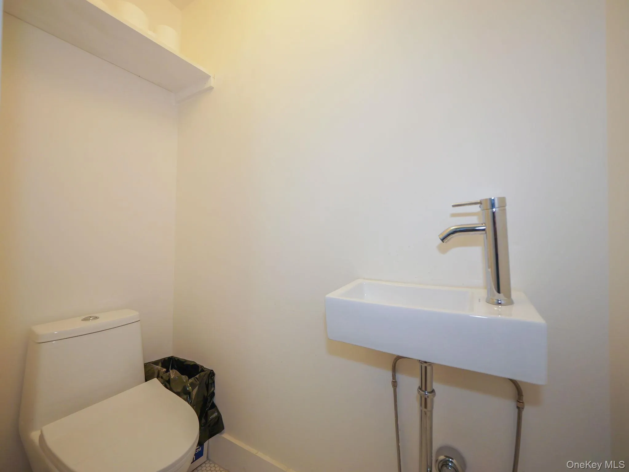 Bathroom featuring toilet and a sink Bathroom featuring toilet and a sink