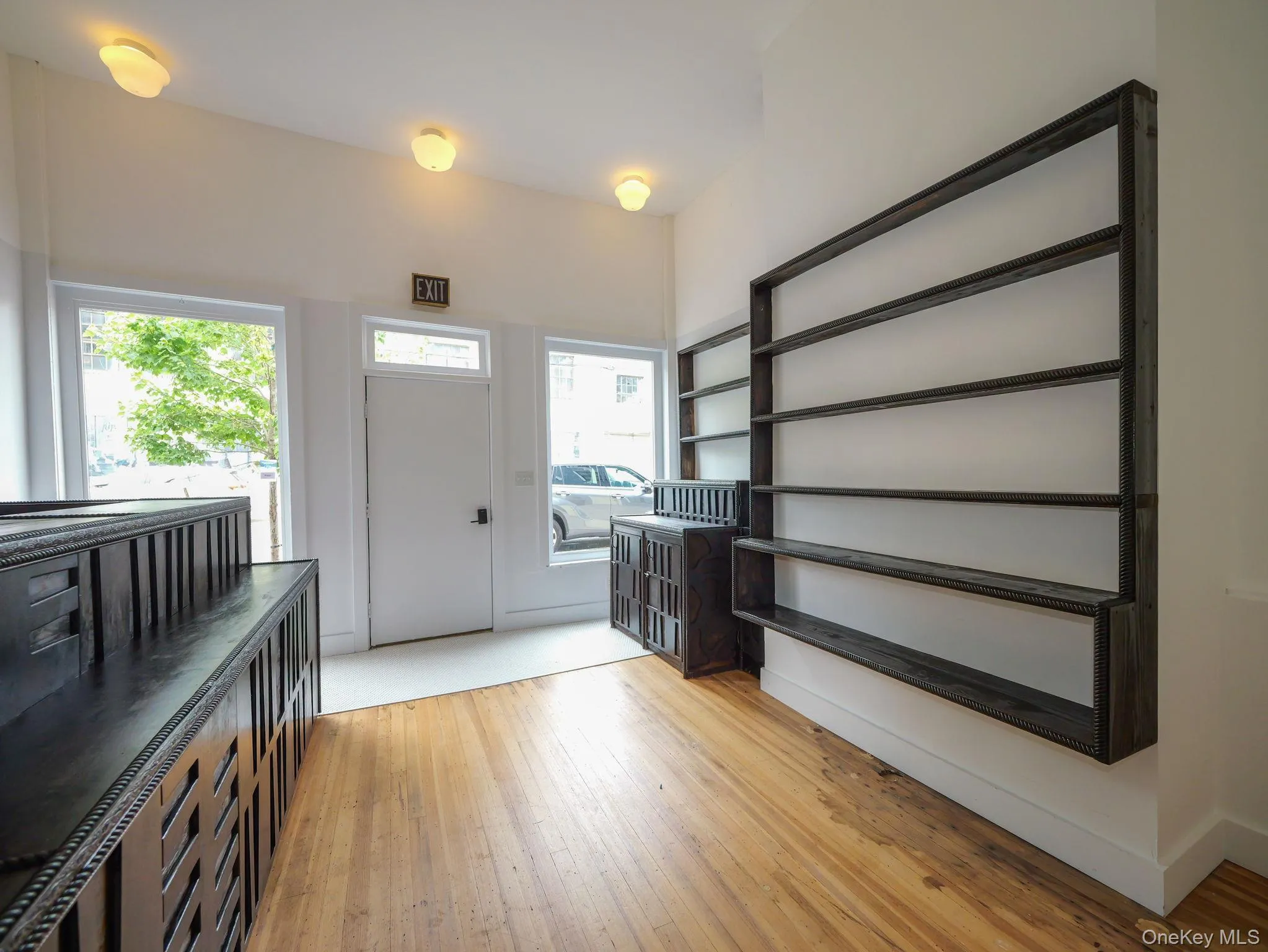 Storefront space with light wood-style flooring Storefront space with light wood-style flooring