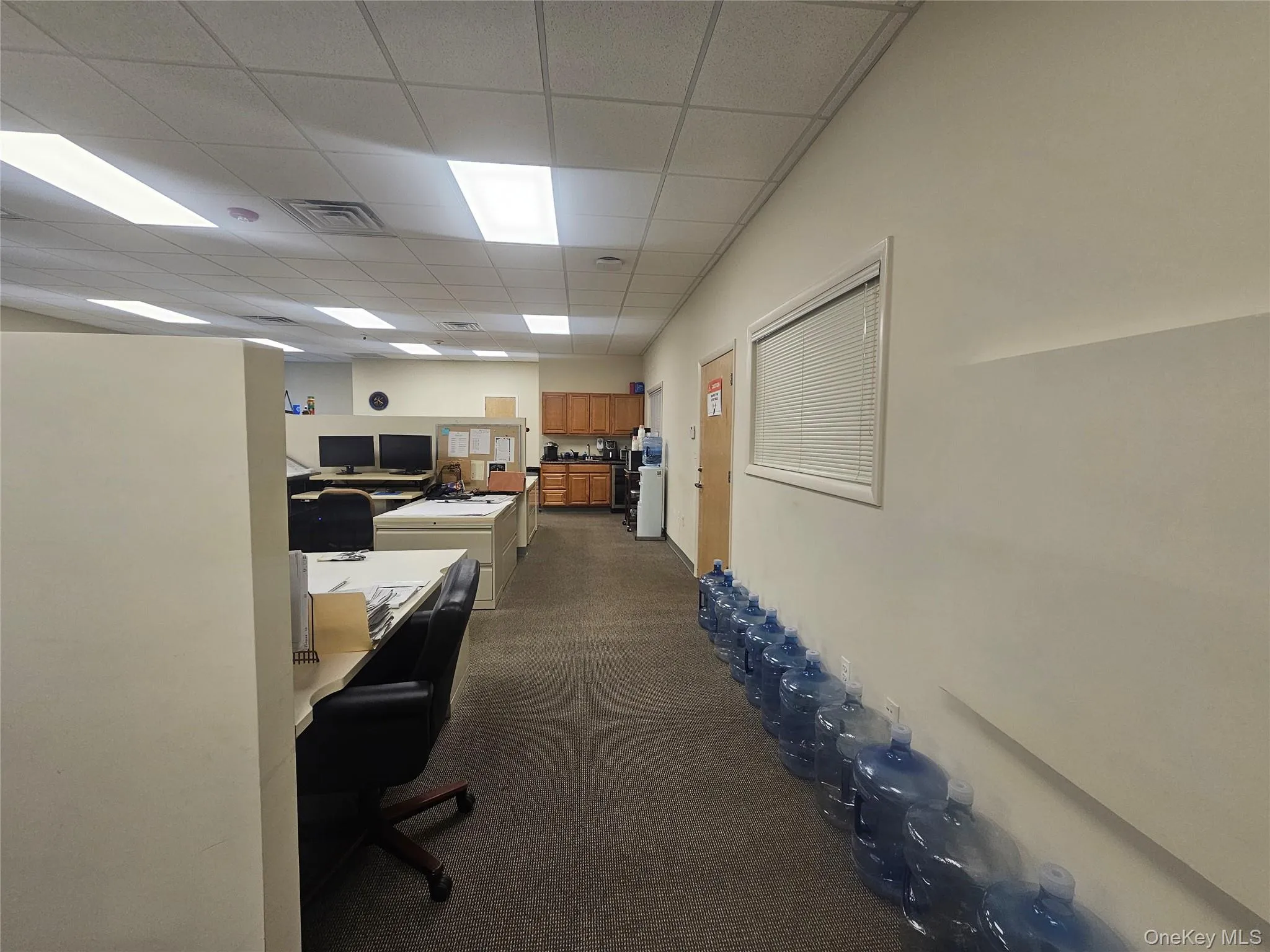 Office area featuring a drop ceiling Office area featuring a drop ceiling
