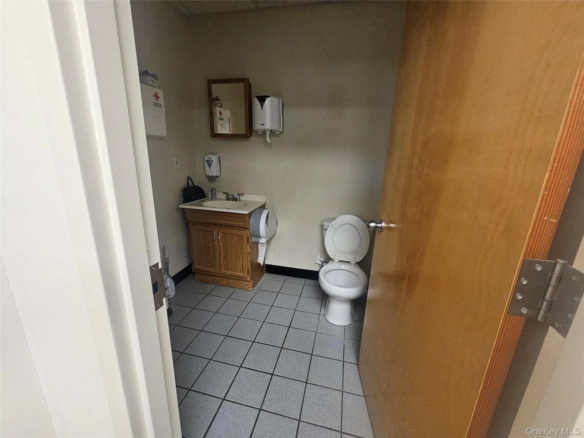Bathroom featuring light tile patterned floors and vanity Bathroom featuring light tile patterned floors and vanity