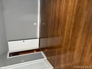 Empty room featuring dark wood-type flooring and lofted ceiling Empty room featuring dark wood-type flooring and lofted ceiling