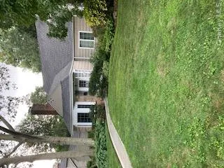 View of front facade with a front yard and a chimney View of front facade with a front yard and a chimney