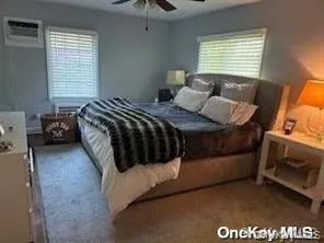 Carpeted bedroom featuring ceiling fan Carpeted bedroom featuring ceiling fan