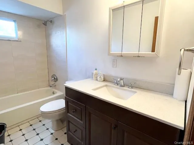 Full bathroom with vanity and shower / bath combination Full bathroom with vanity and shower / bath combination