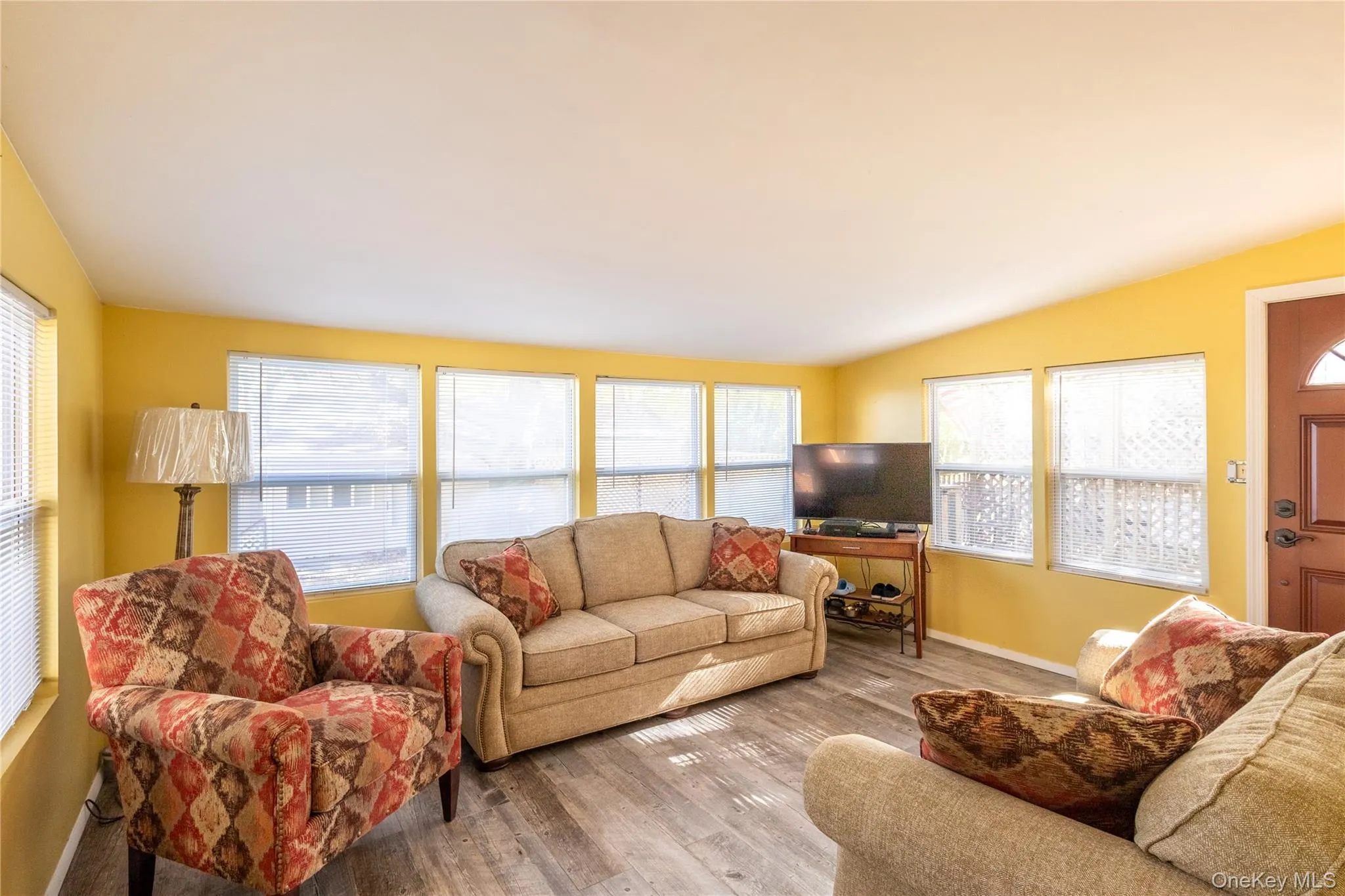 Living room featuring healthy amount of natural light and wood finished floors Living room featuring healthy amount of natural light and wood finished floors