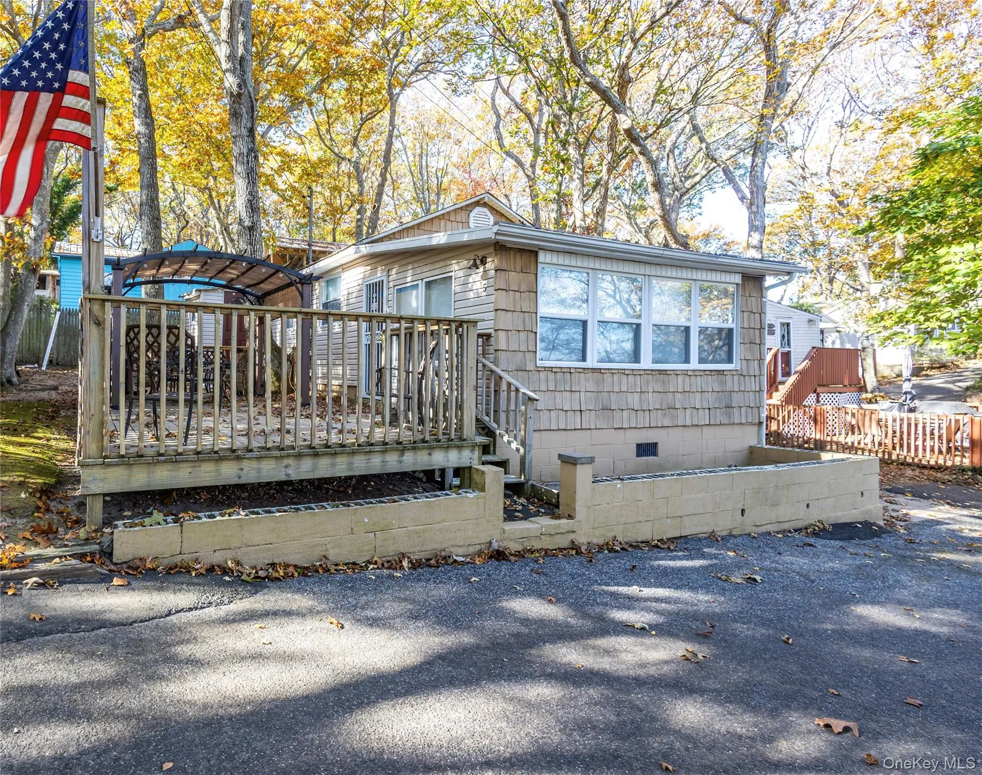 Rear view of property featuring a wooden deck and crawl space Rear view of property featuring a wooden deck and crawl space