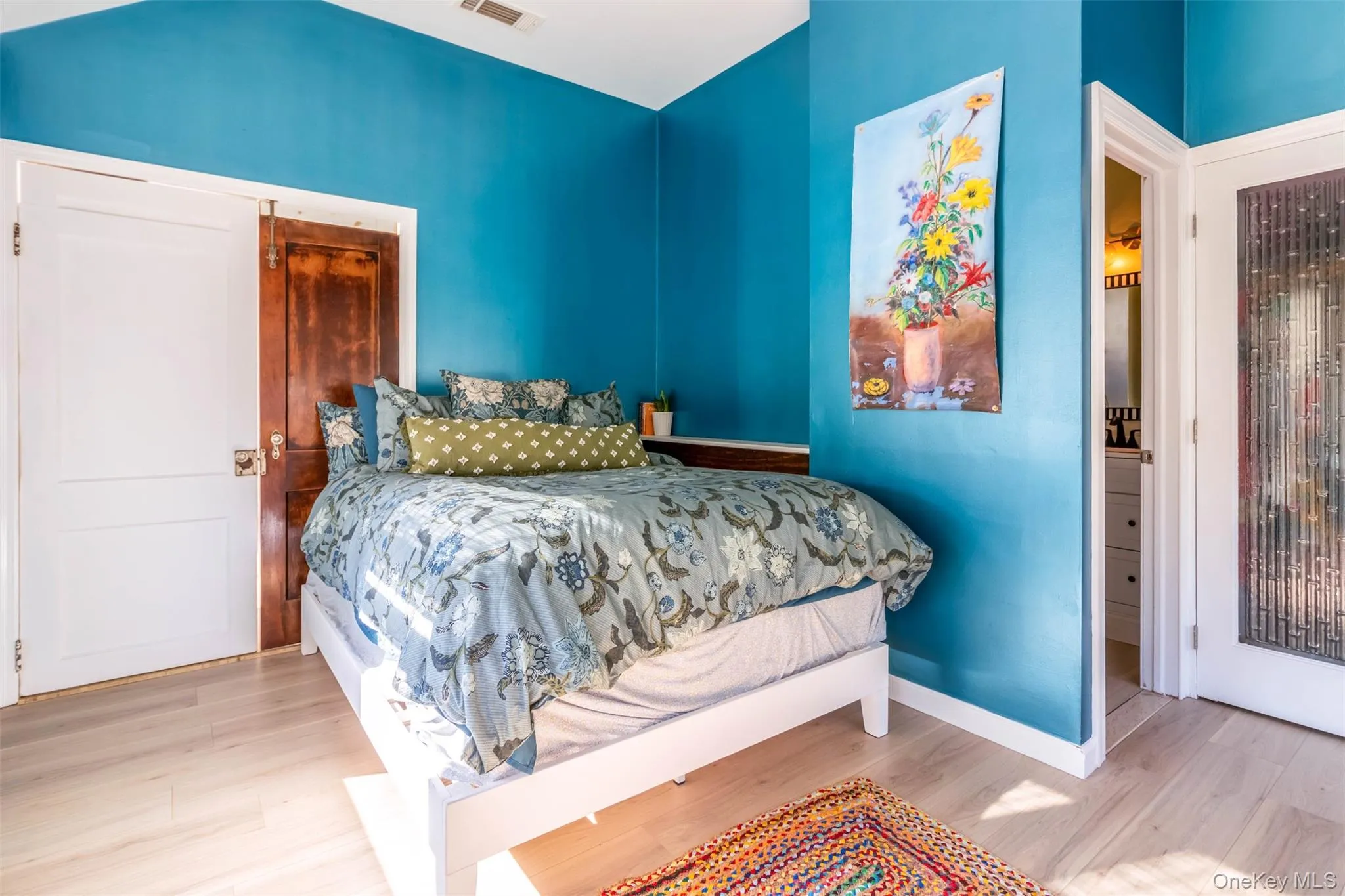 Bedroom featuring wood finished floors and baseboards Bedroom featuring wood finished floors and baseboards