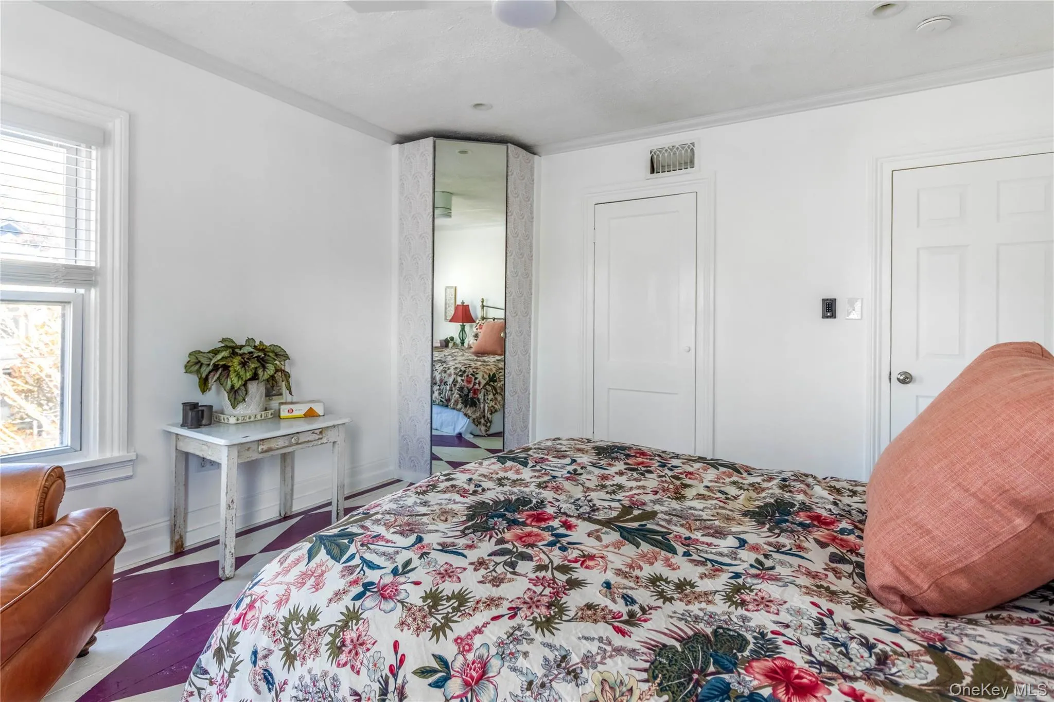 Bedroom featuring crown molding, a ceiling fan, a closet, and dark wood-style flooring Bedroom featuring crown molding, a ceiling fan, a closet, and dark wood-style flooring