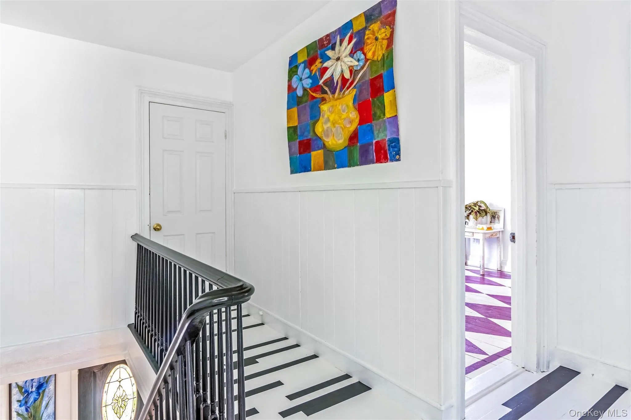 Stairway featuring wainscoting Stairway featuring wainscoting