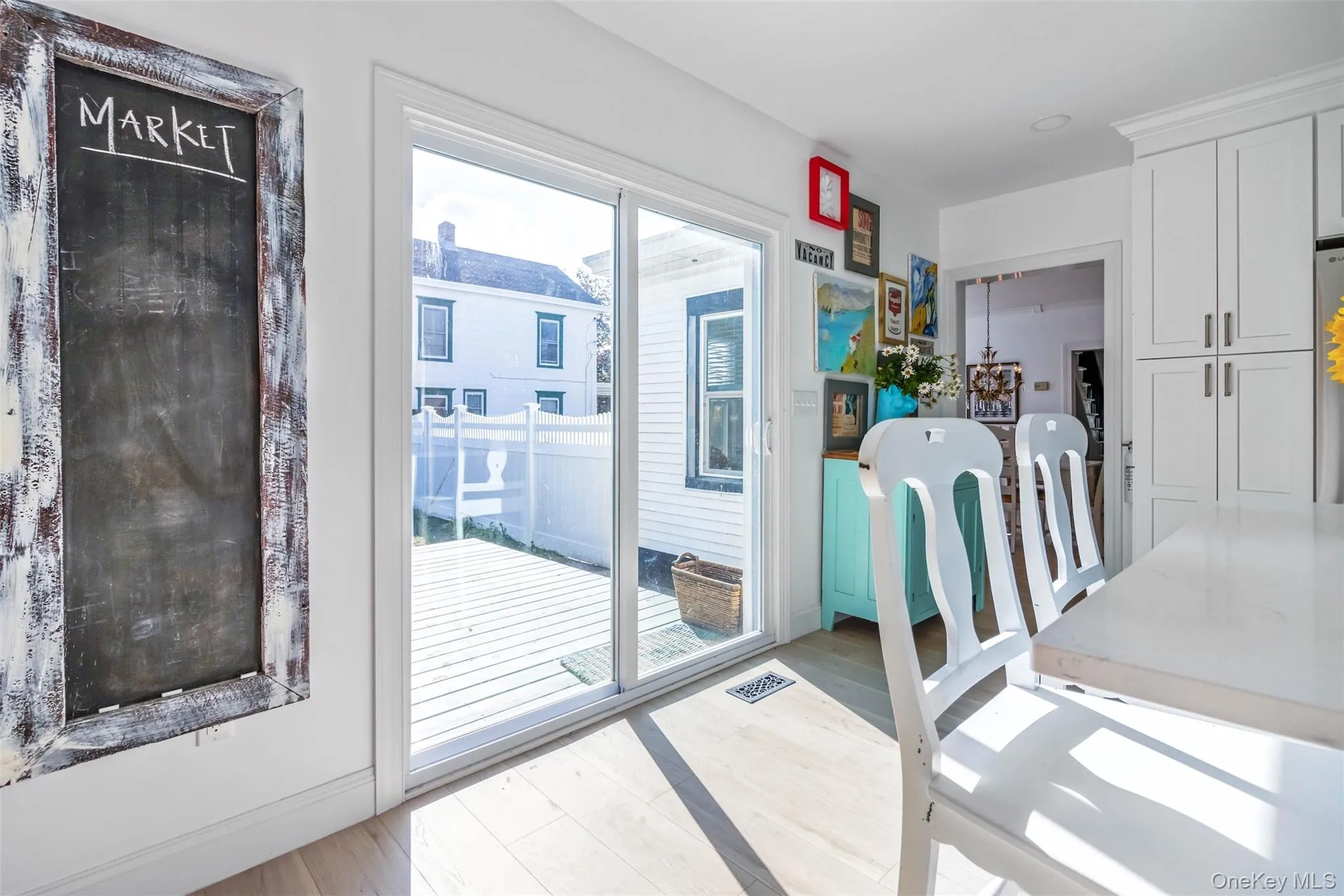 Doorway to outside with wood finished floors and baseboards Doorway to outside with wood finished floors and baseboards