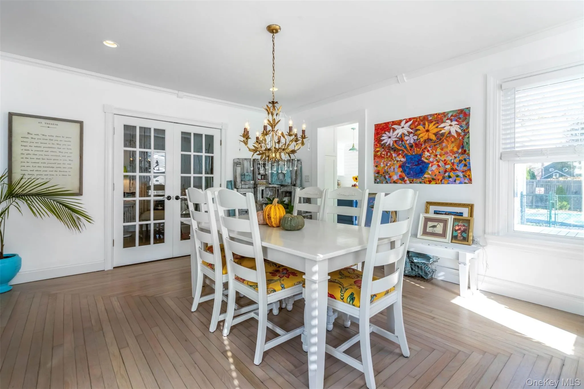 Dining area with french doors, a chandelier, ornamental molding, and wood finished floors Dining area with french doors, a chandelier, ornamental molding, and wood finished floors
