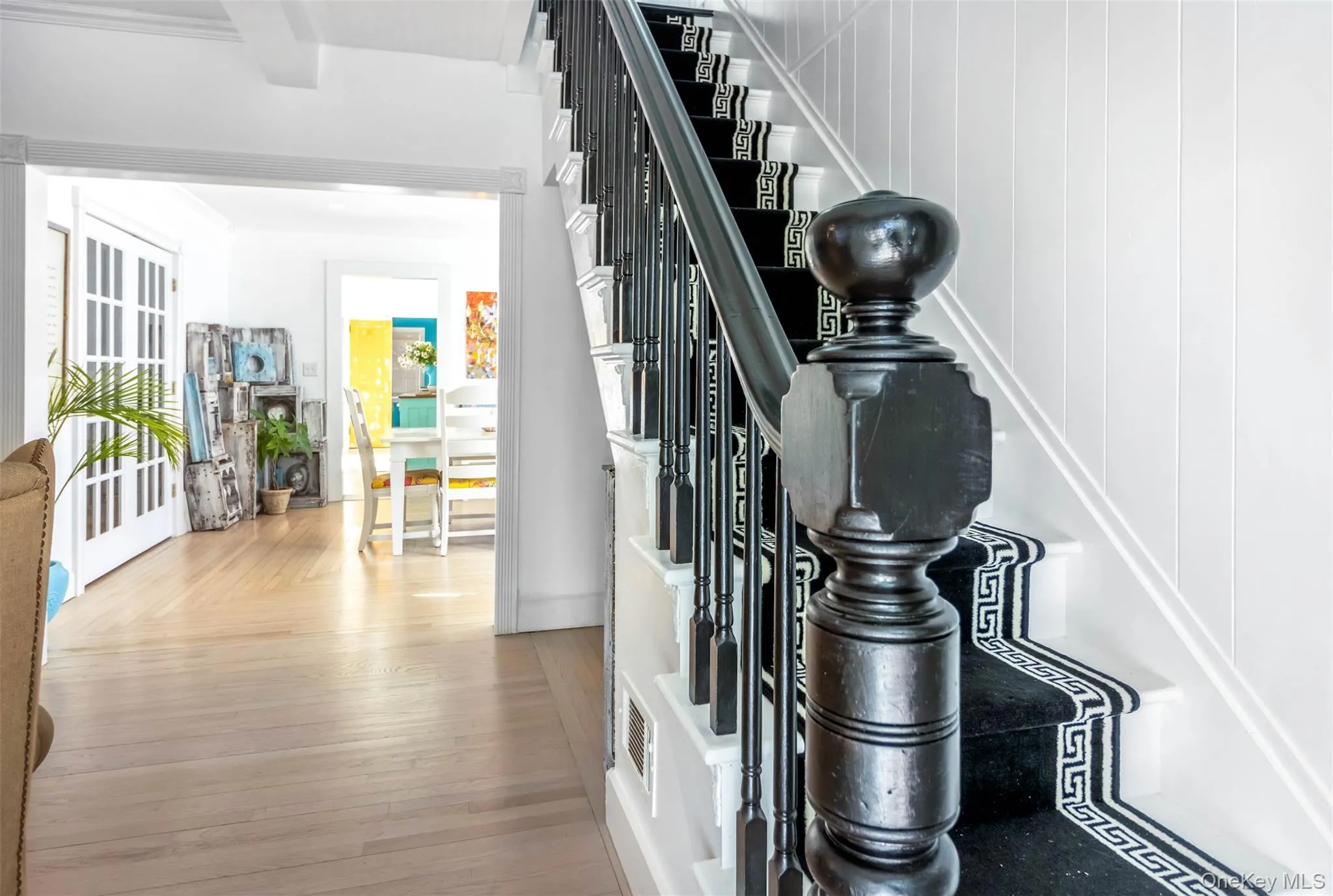 Staircase featuring wood finished floors Staircase featuring wood finished floors