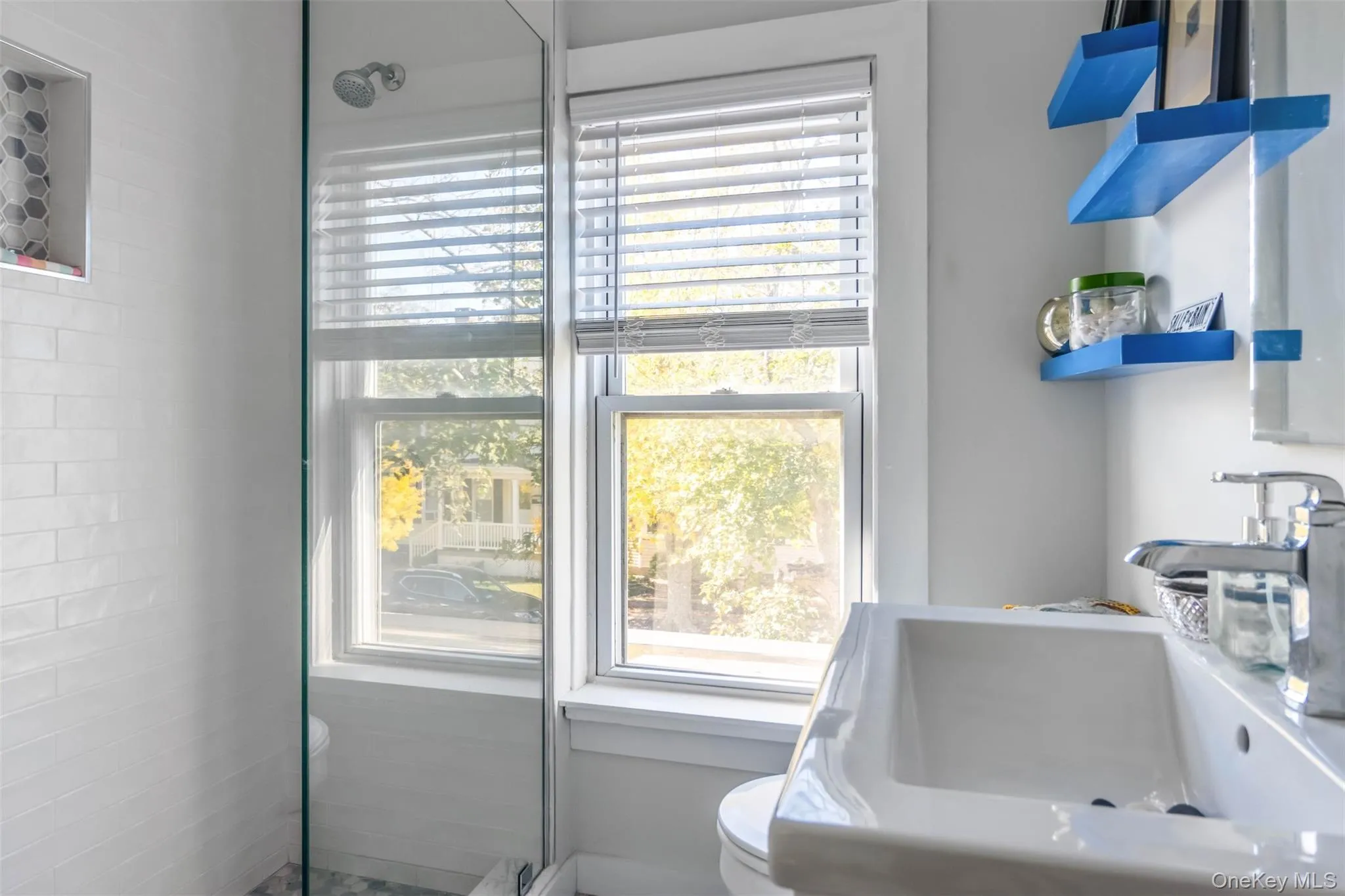 Bathroom featuring plenty of natural light and a walk in shower Bathroom featuring plenty of natural light and a walk in shower