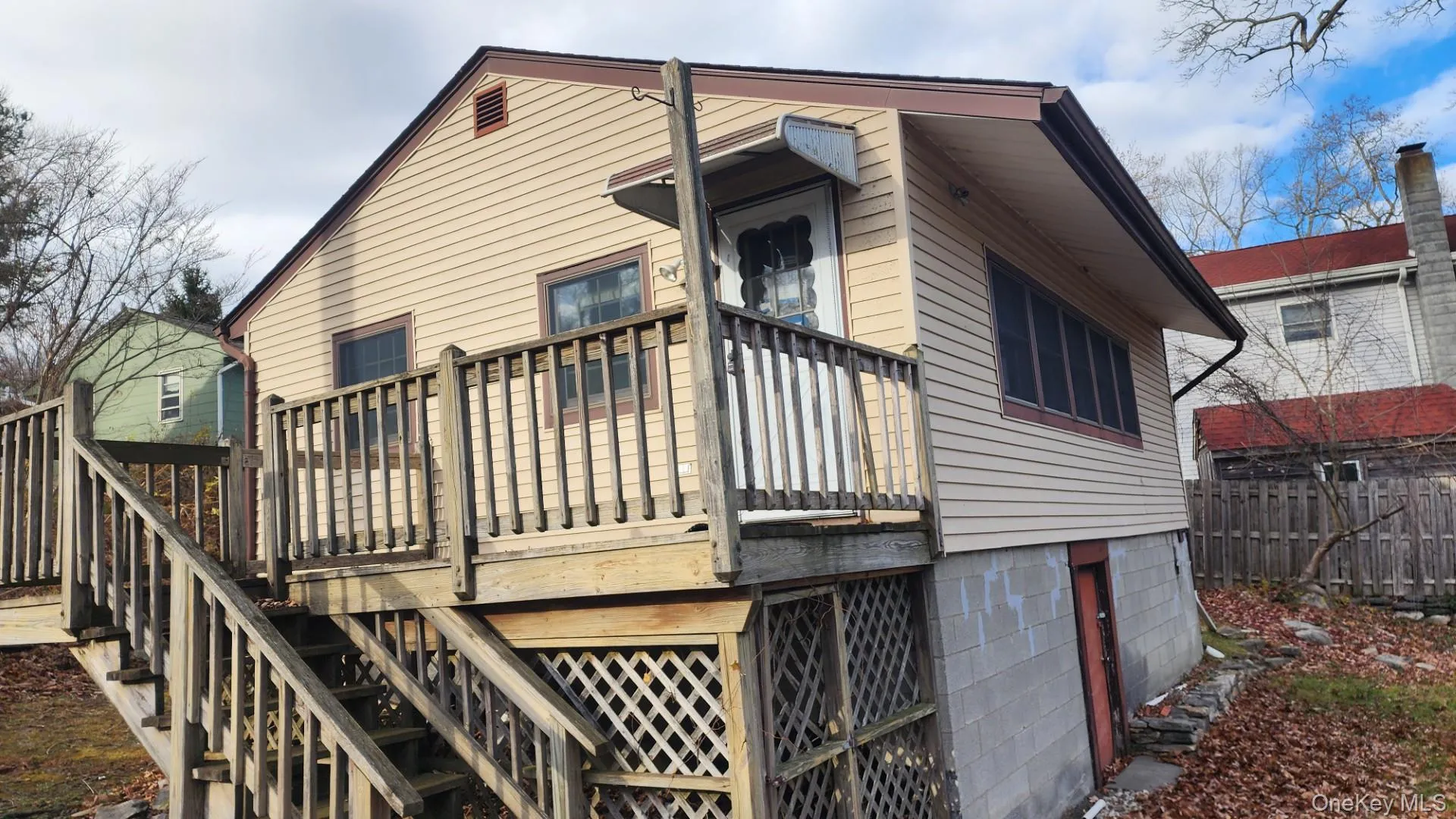 Back of house with a wooden deck Back of house with a wooden deck