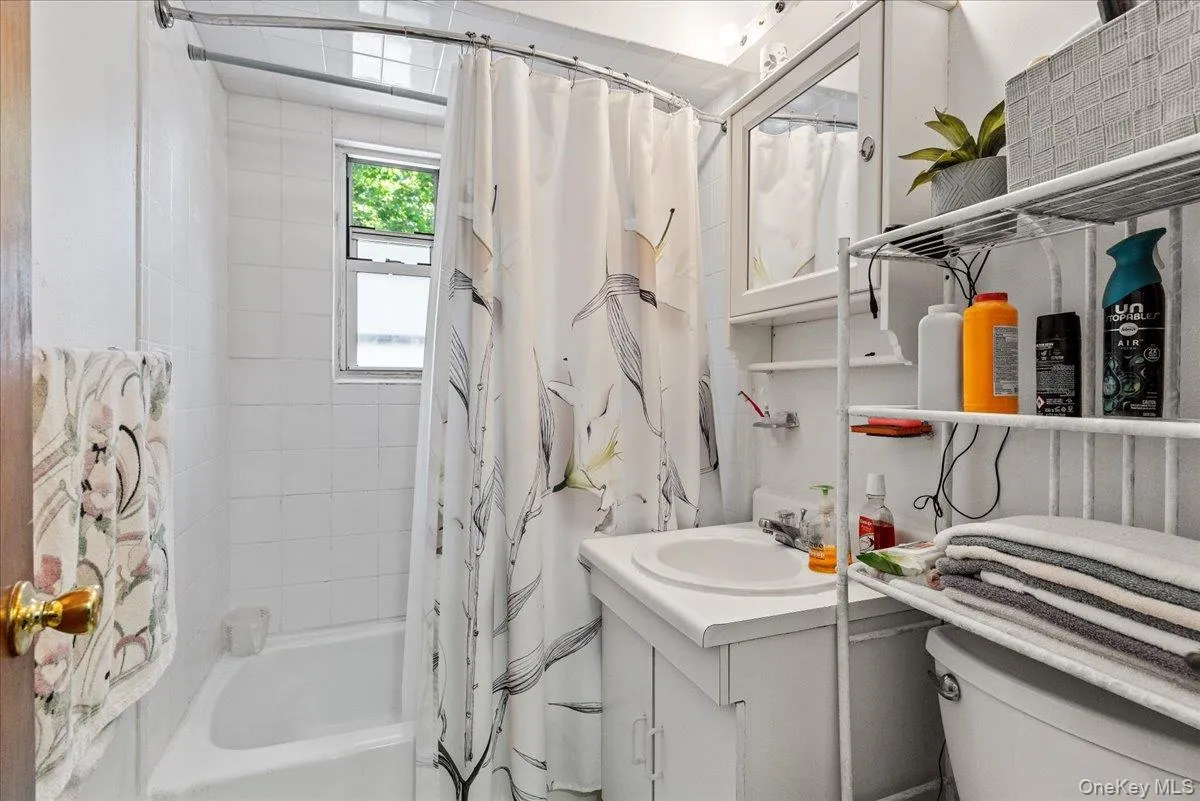 Full bath featuring vanity and shower / bath combination with curtain Full bath featuring vanity and shower / bath combination with curtain