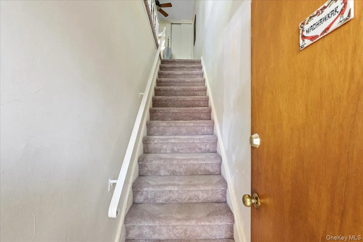 Staircase featuring baseboards Staircase featuring baseboards