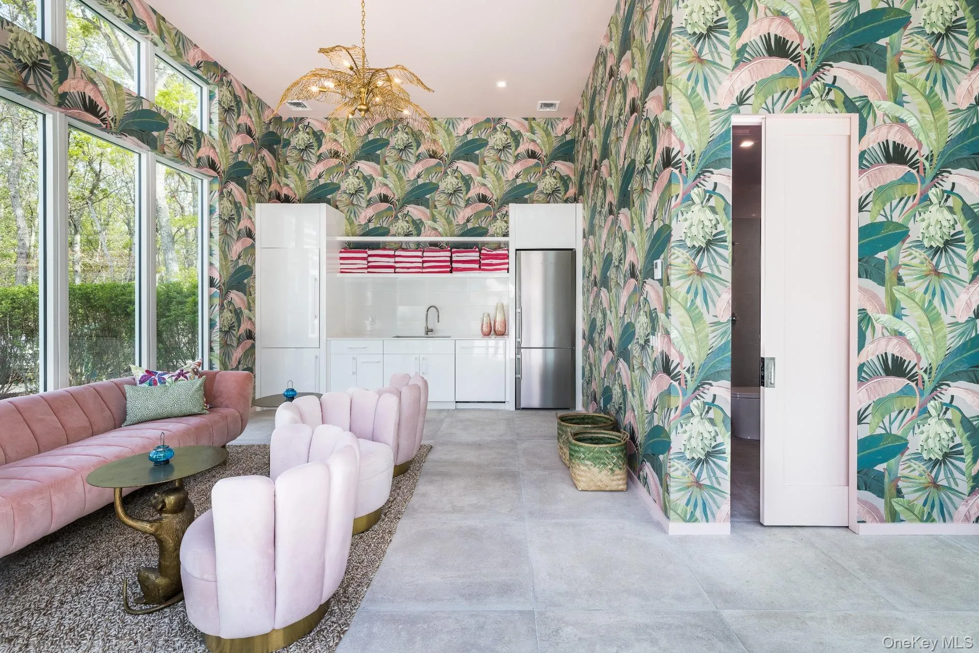 Living room with wallpapered walls, concrete flooring, and a towering ceiling Living room with wallpapered walls, concrete flooring, and a towering ceiling