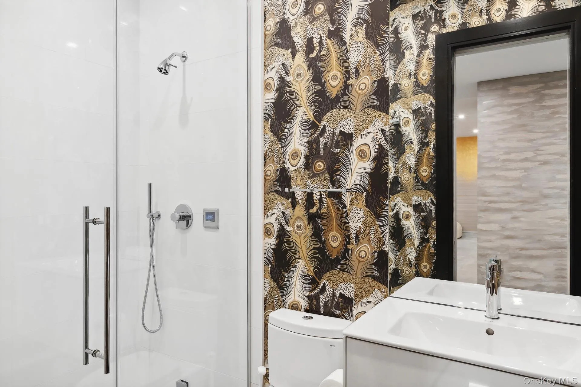 Full bath featuring vanity and a shower stall Full bath featuring vanity and a shower stall