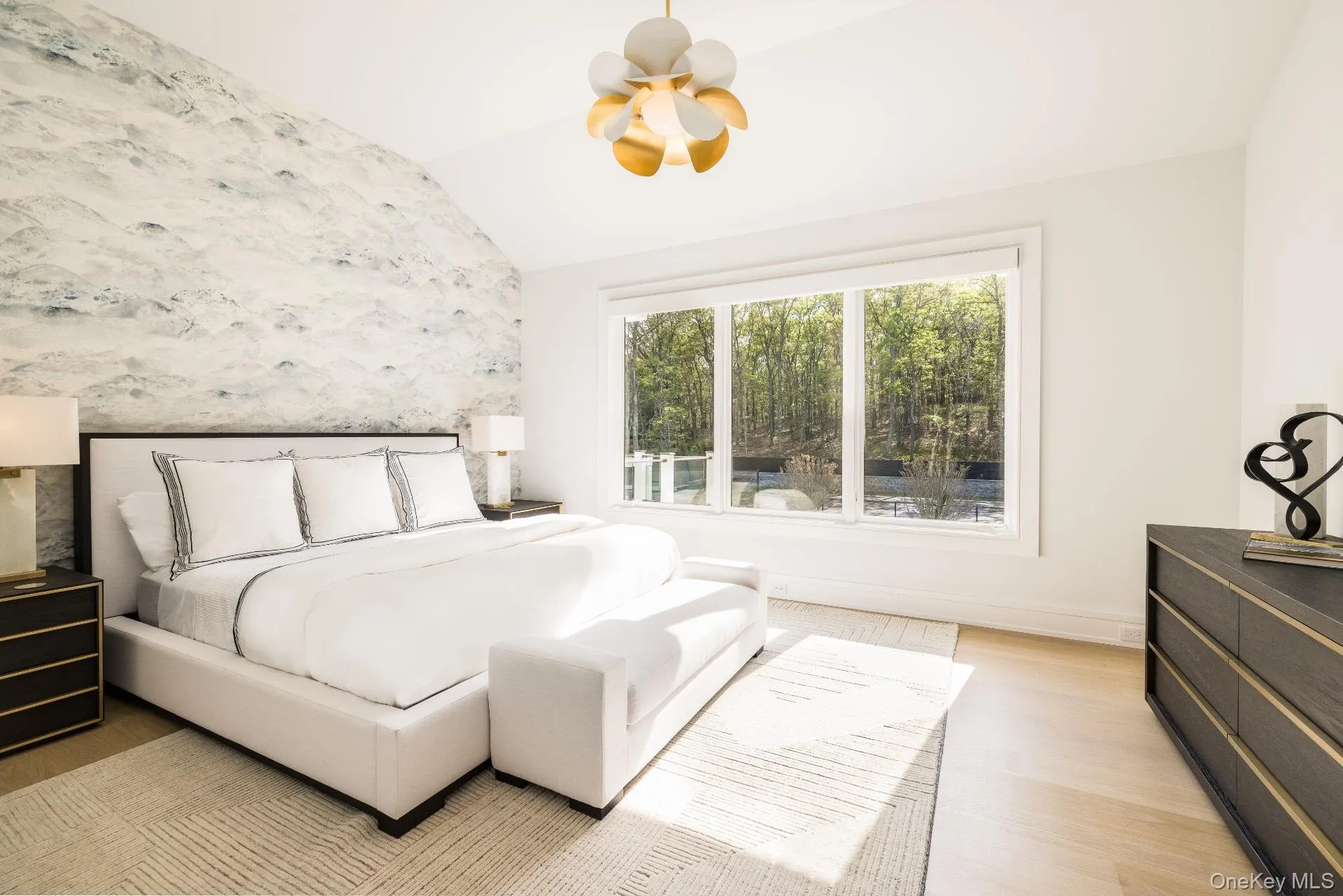 Bedroom with vaulted ceiling and light wood-style floors Bedroom with vaulted ceiling and light wood-style floors