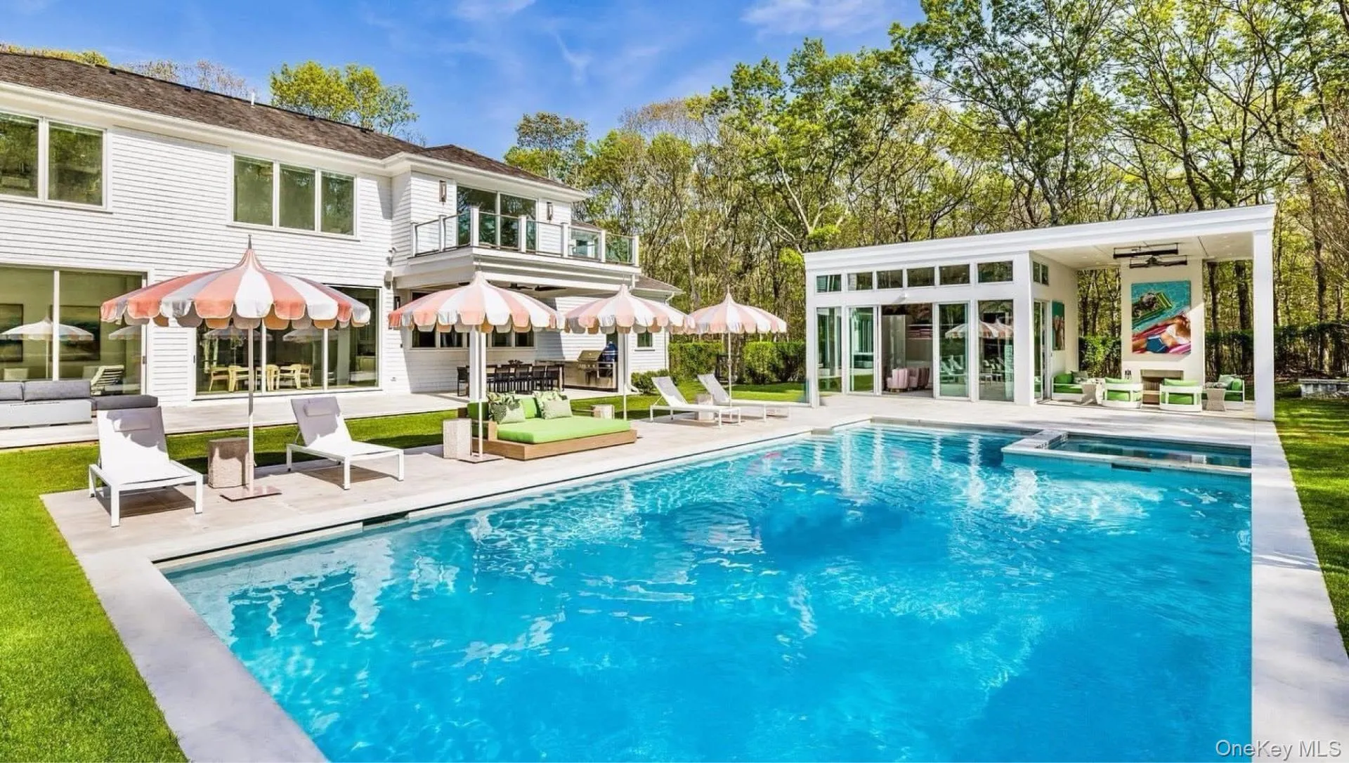 Rear view of house with a patio, a pool with connected hot tub, an exterior structure, a balcony, and an outdoor structure Rear view of house with a patio, a pool with connected hot tub, an exterior structure, a balcony, and an outdoor structure