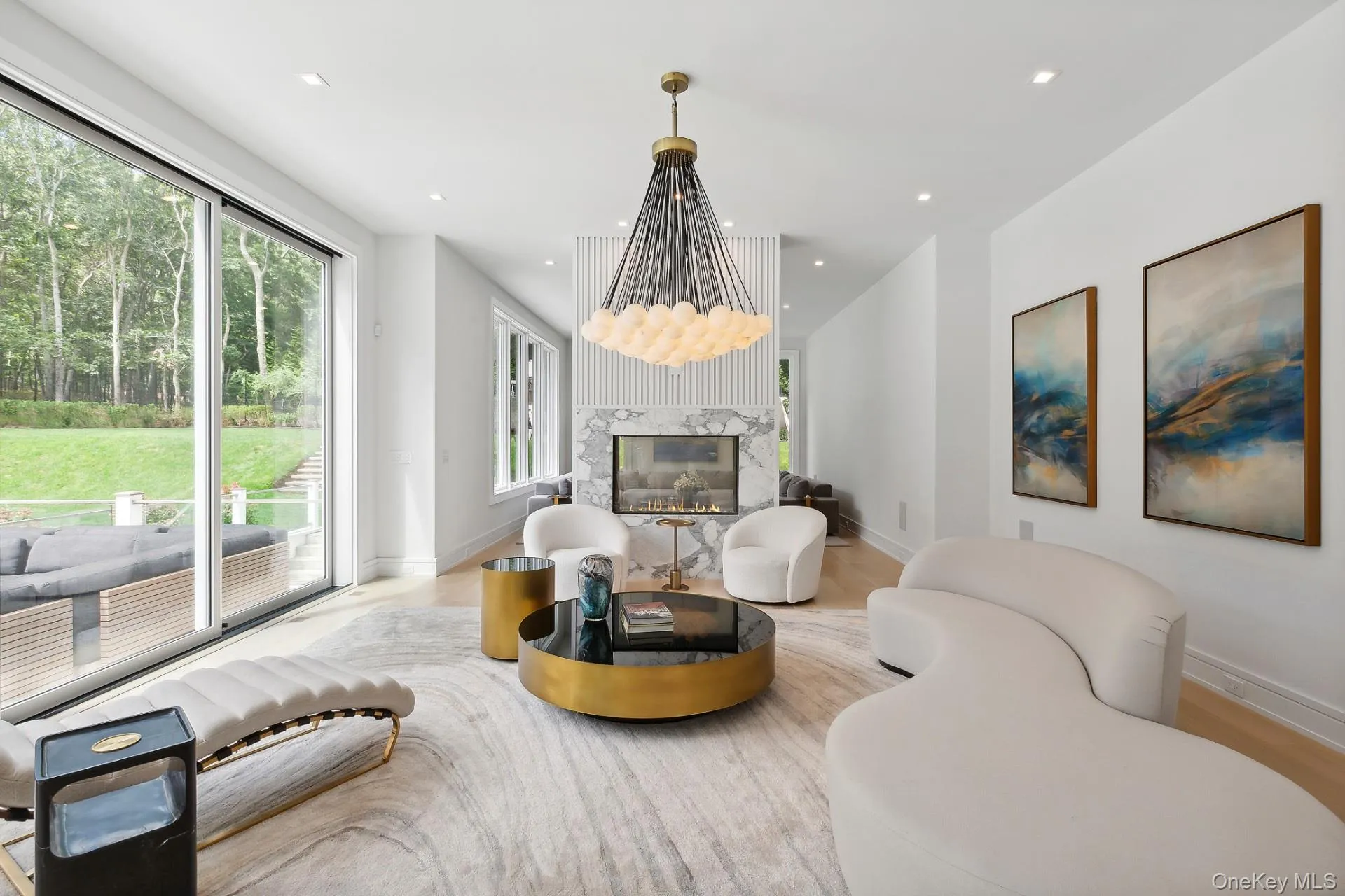 Living room featuring recessed lighting, a fireplace, and light wood finished floors Living room featuring recessed lighting, a fireplace, and light wood finished floors