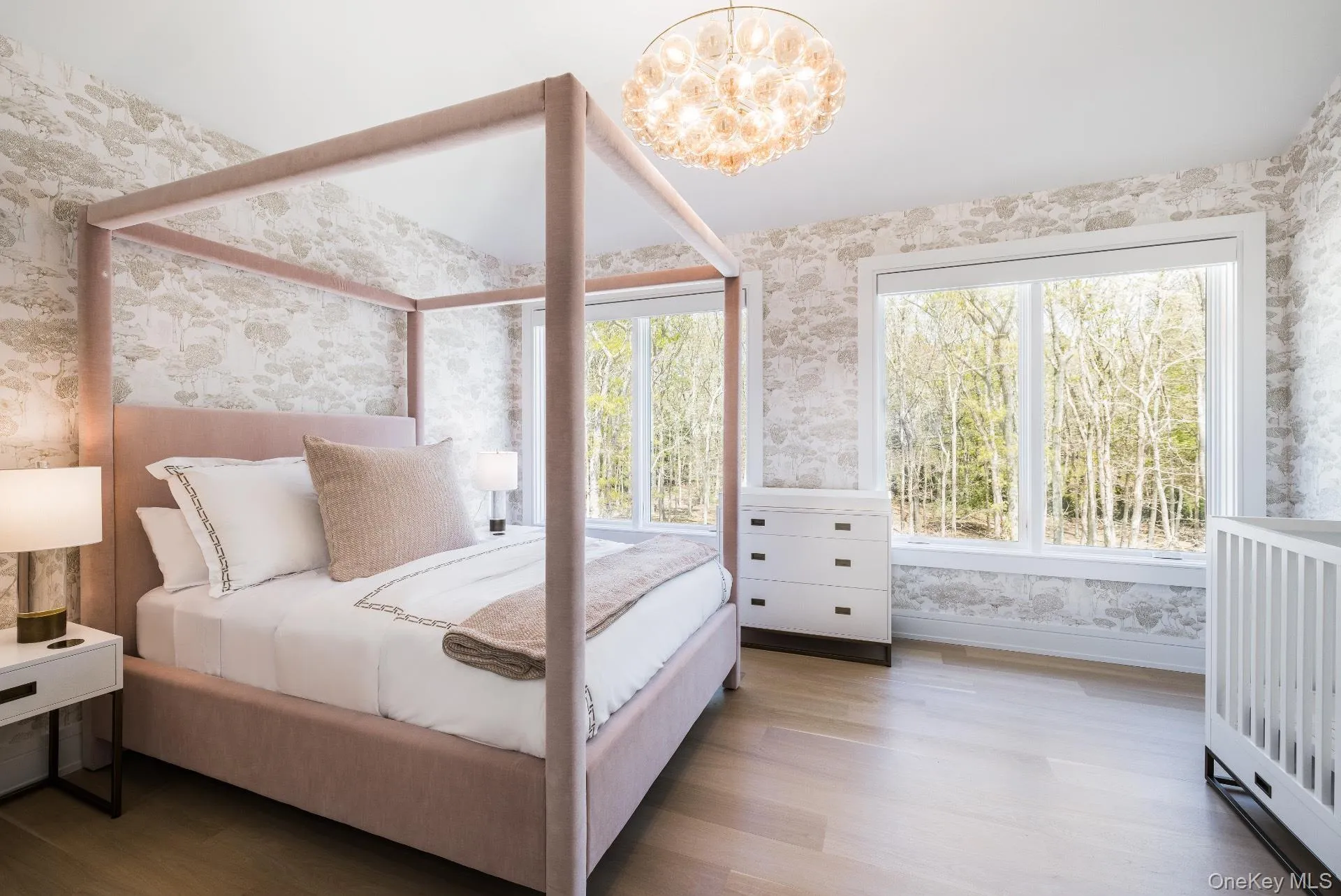 Bedroom with wallpapered walls, wood finished floors, and a chandelier Bedroom with wallpapered walls, wood finished floors, and a chandelier