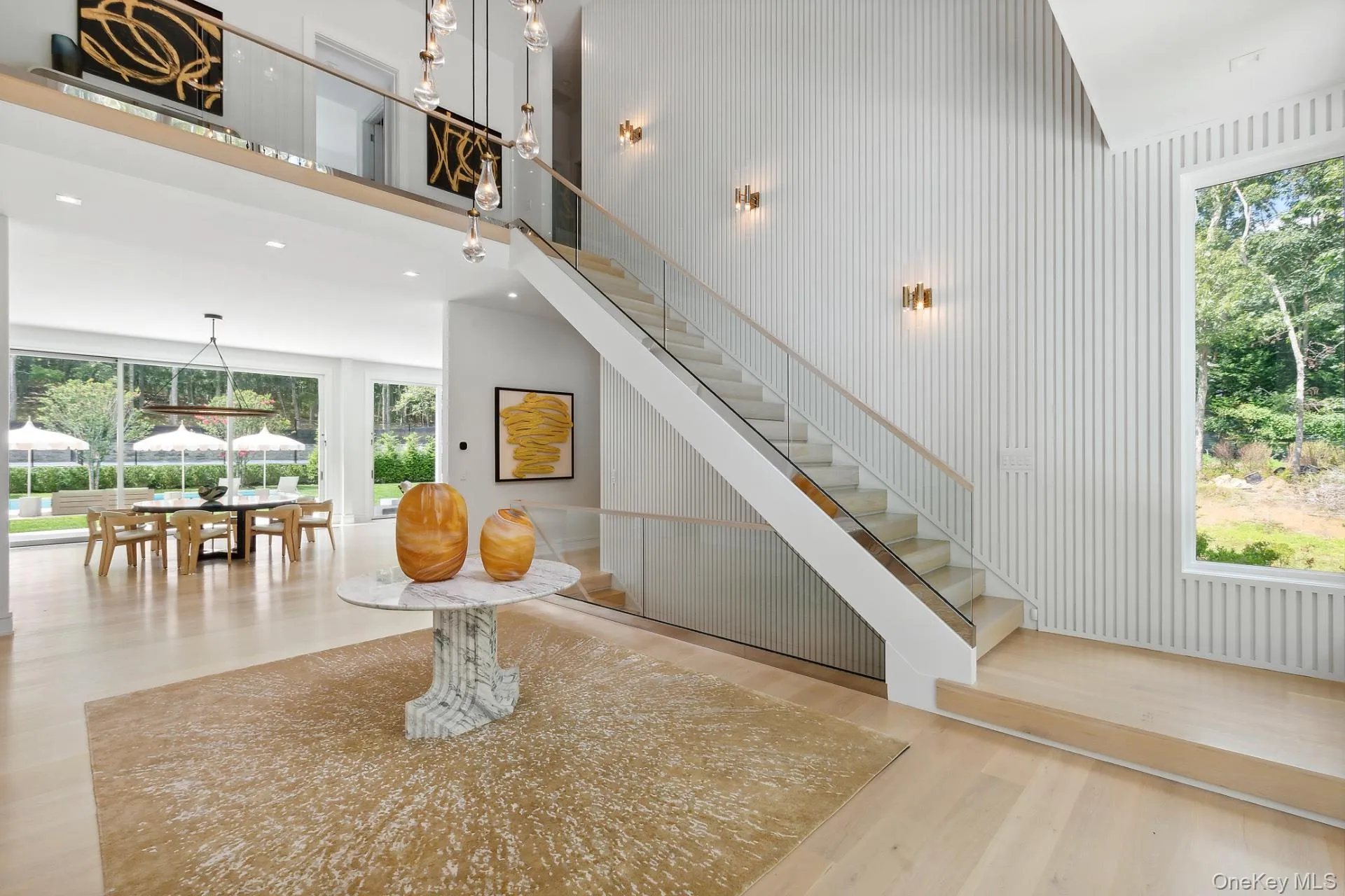 Stairway featuring plenty of natural light, a high ceiling, wood finished floors, and recessed lighting Stairway featuring plenty of natural light, a high ceiling, wood finished floors, and recessed lighting