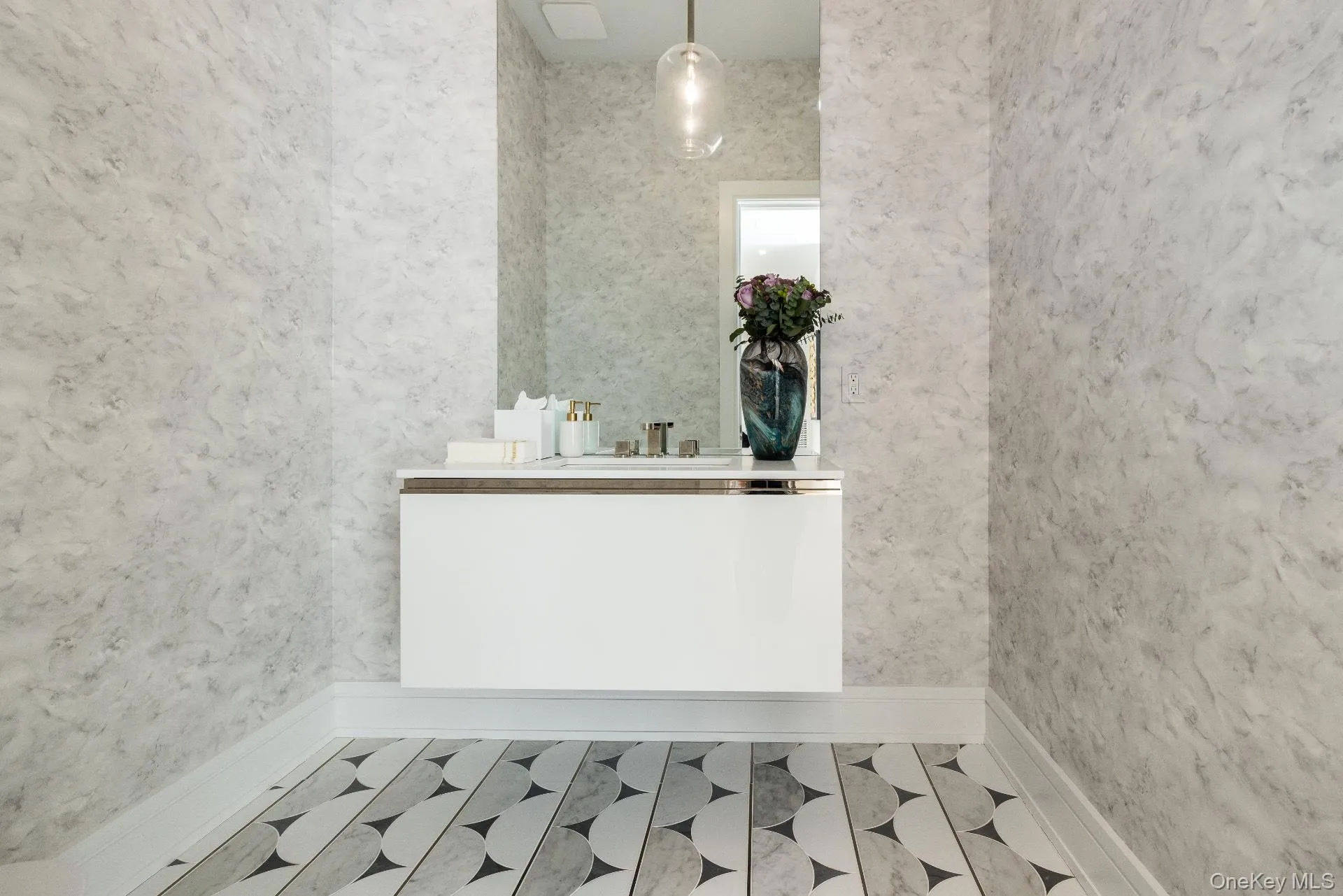 Bathroom featuring vanity and wallpapered walls Bathroom featuring vanity and wallpapered walls