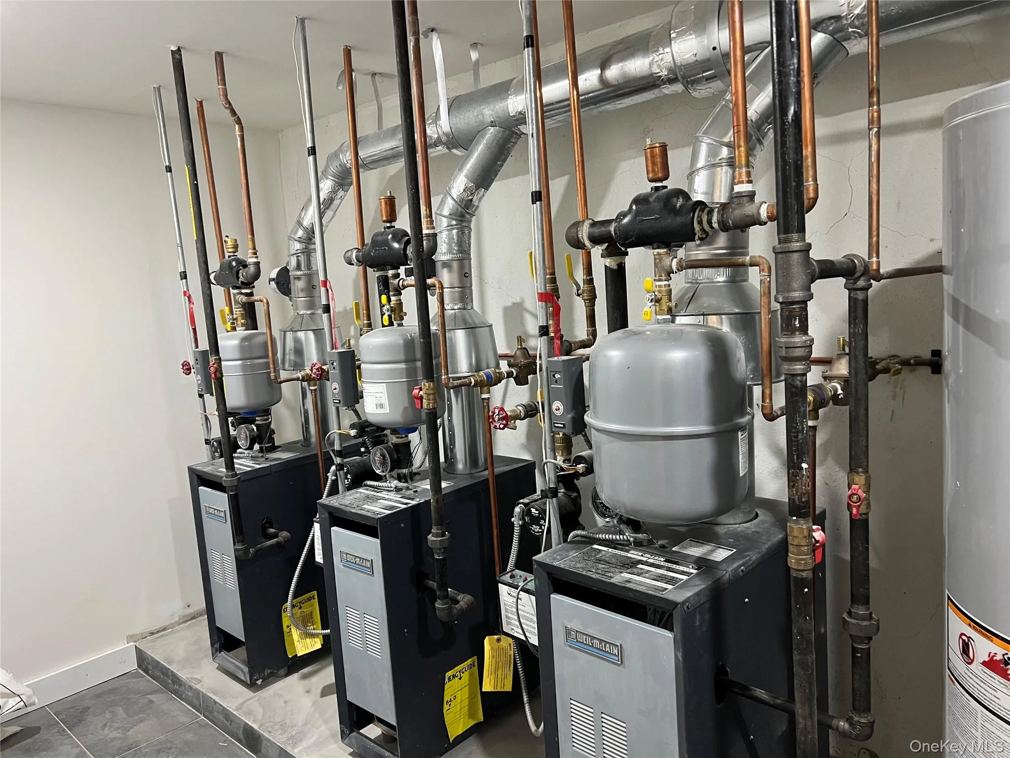 Utility room featuring a heating unit and gas water heater Utility room featuring a heating unit and gas water heater