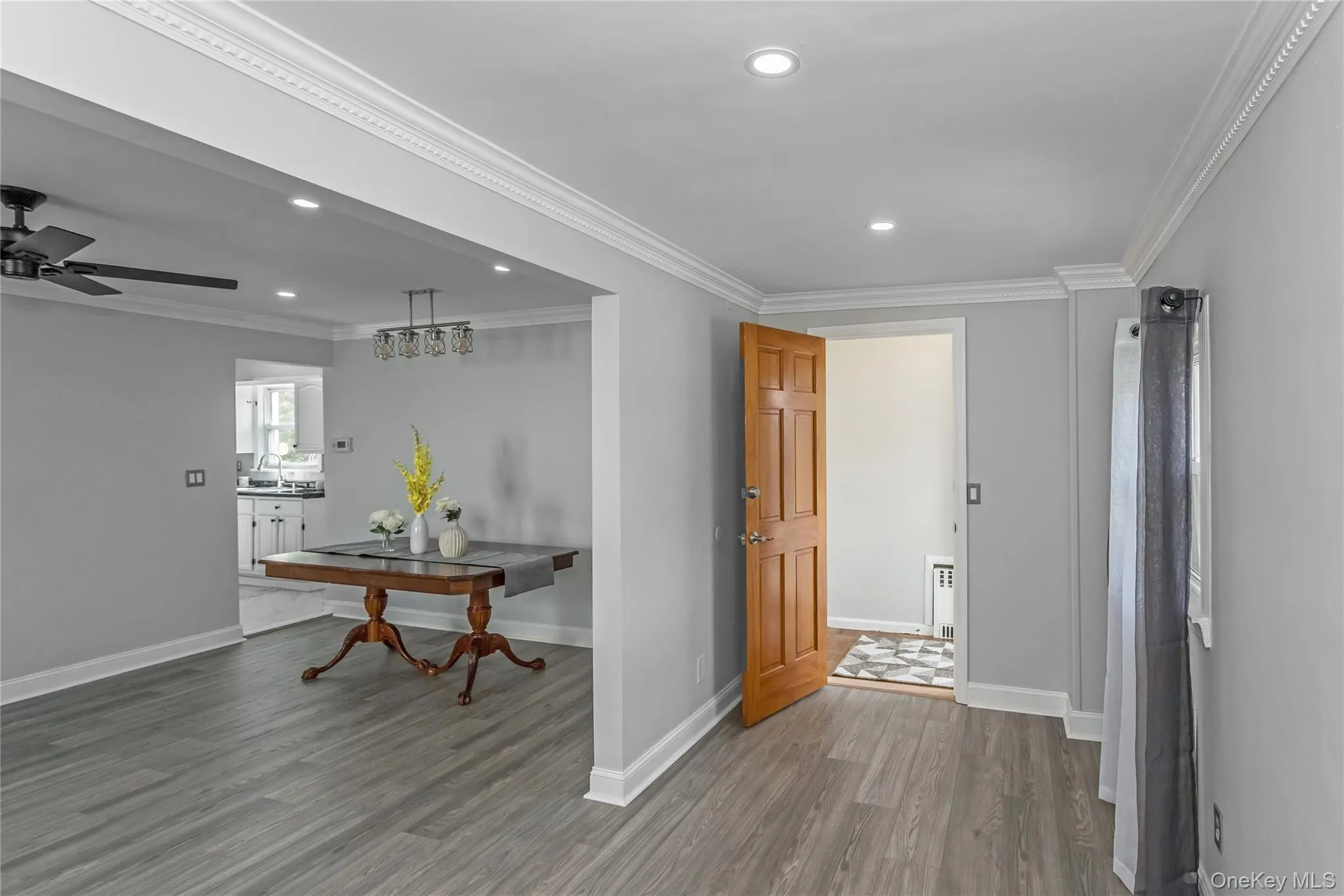 Hall with recessed lighting, baseboards, and wood finished floors Hall with recessed lighting, baseboards, and wood finished floors