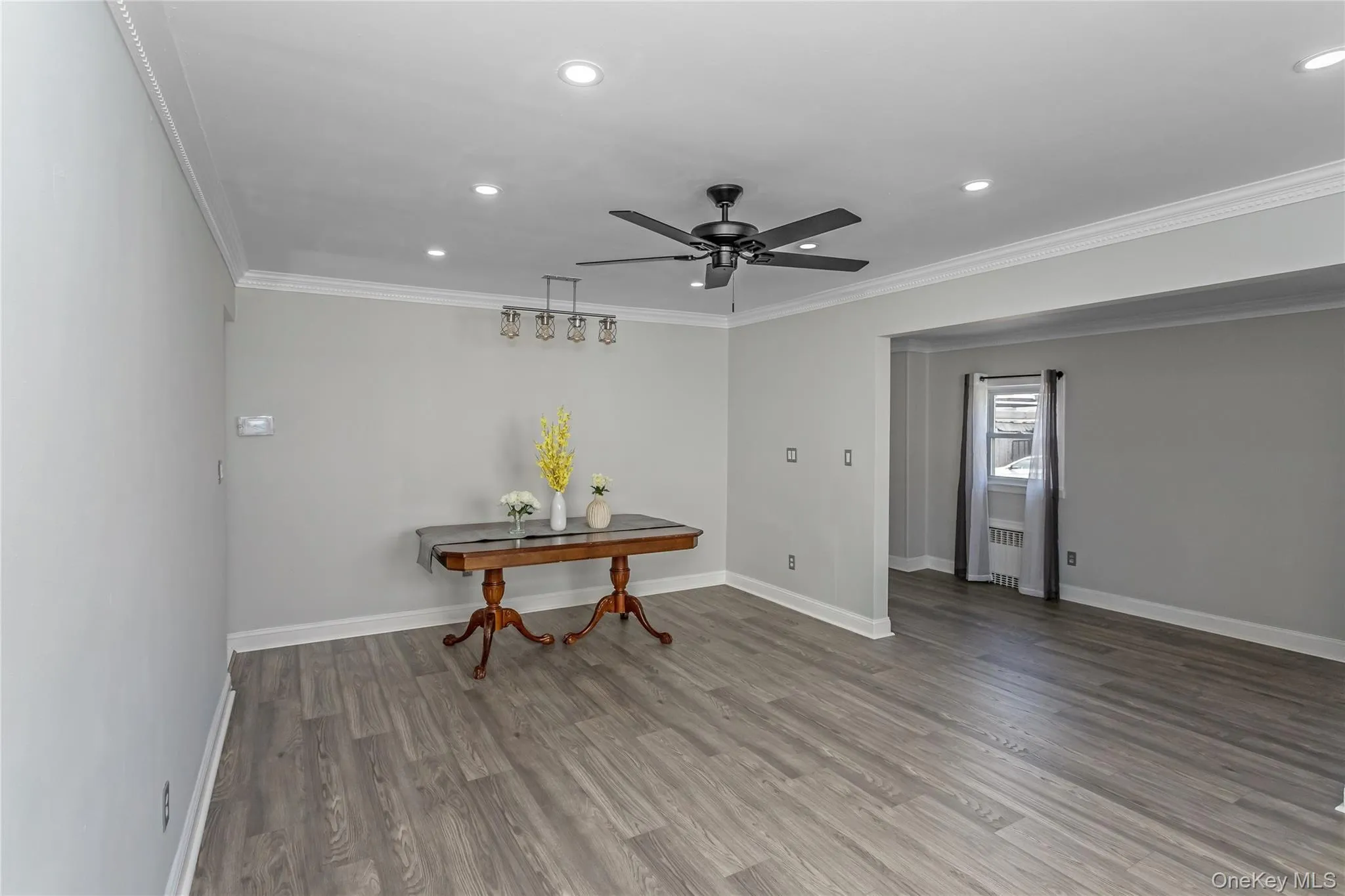 Dining space with a ceiling fan, recessed lighting, ornamental molding, and wood finished floors Dining space with a ceiling fan, recessed lighting, ornamental molding, and wood finished floors