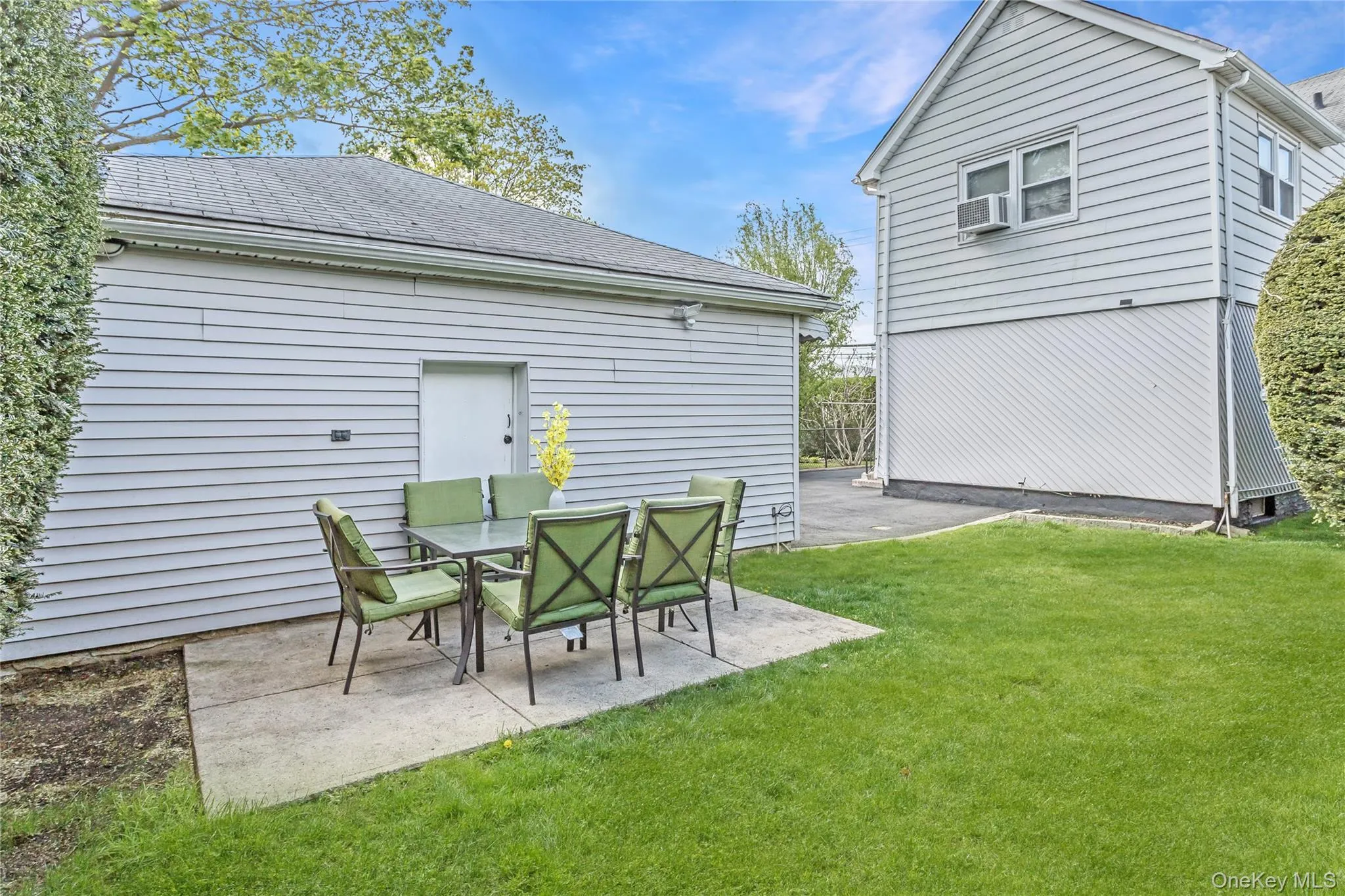Back of house with a patio, roof with shingles, and a yard Back of house with a patio, roof with shingles, and a yard
