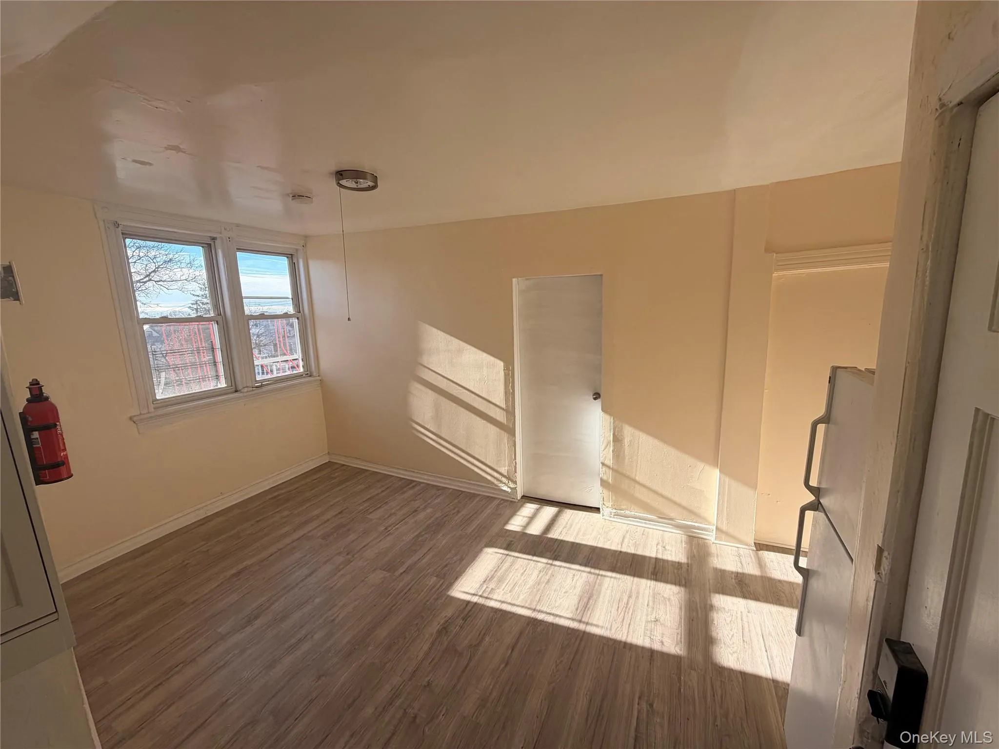 Spare room with dark wood finished floors and baseboards Spare room with dark wood finished floors and baseboards