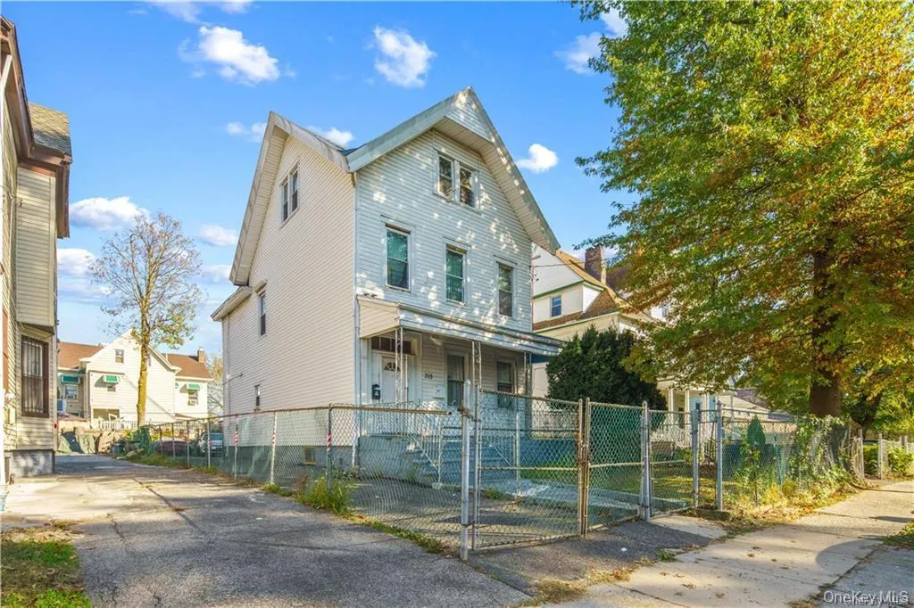 View of front of property featuring covered porch, a gate, and a fenced front yard View of front of property featuring covered porch, a gate, and a fenced front yard